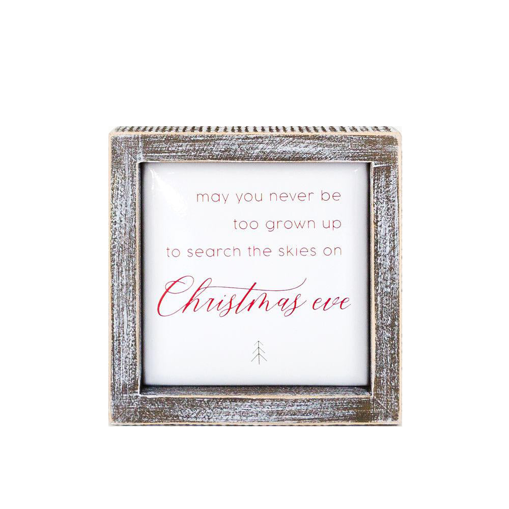A beautifully crafted 5-inch wooden framed sign with metal embossed lettering that reads 'may you never be too grown to search the skies on Christmas eve'.