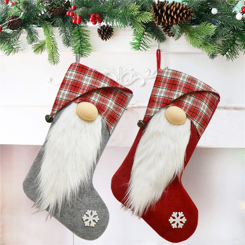 A festive red and gray Christmas stocking featuring a faceless doll design, perfect for holiday decorations and gift storage.