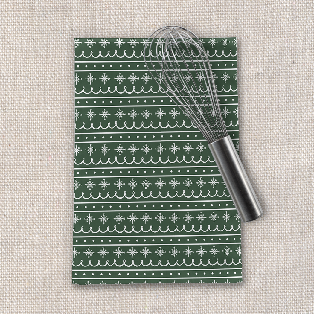 Green Snowflake Pattern Tea Towel made of cotton twill, featuring a cozy design, hemmed edges, and measuring 18x30 inches.