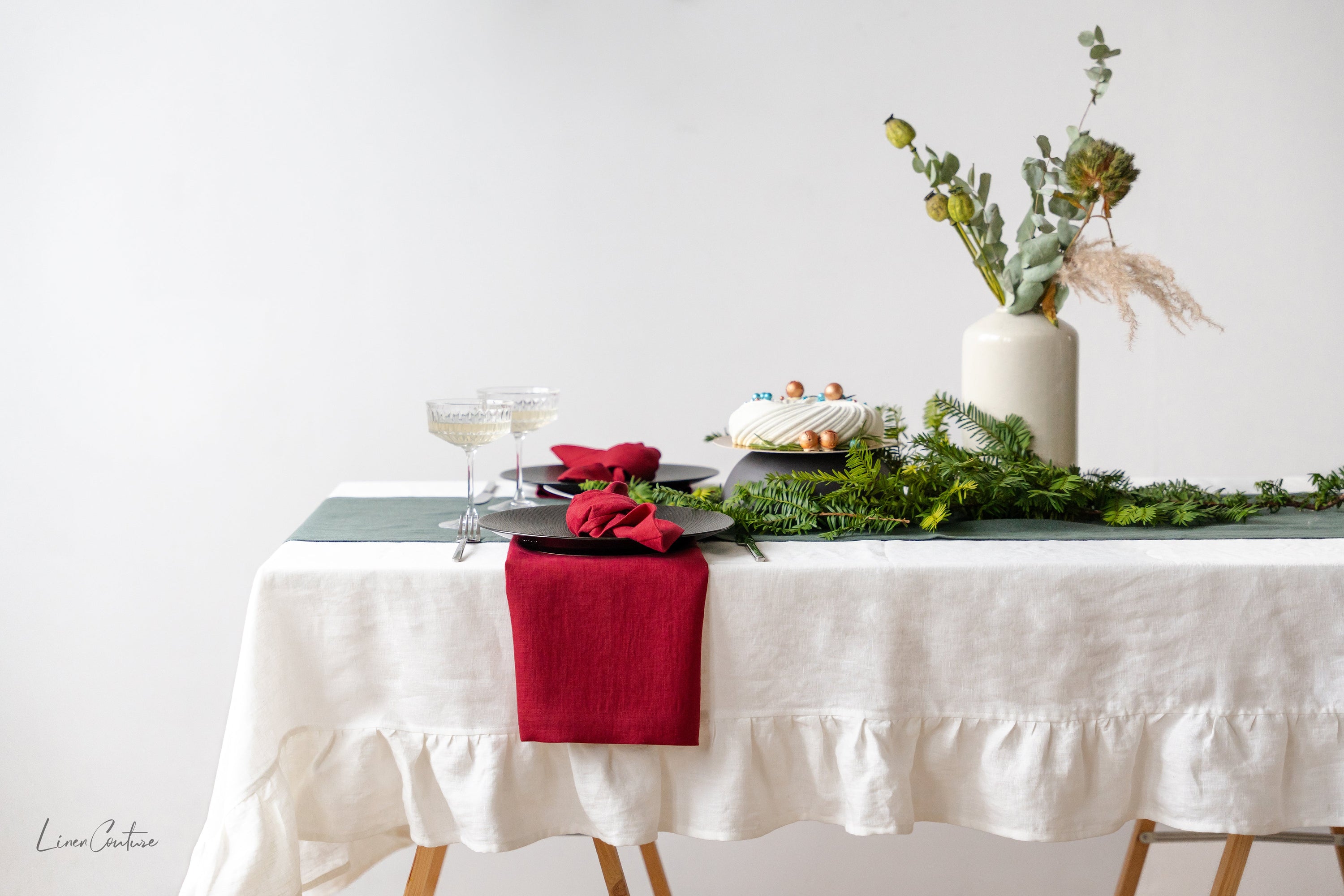 Handmade white linen Christmas tablecloth with elegant ruffles, showcasing premium European linen craftsmanship.