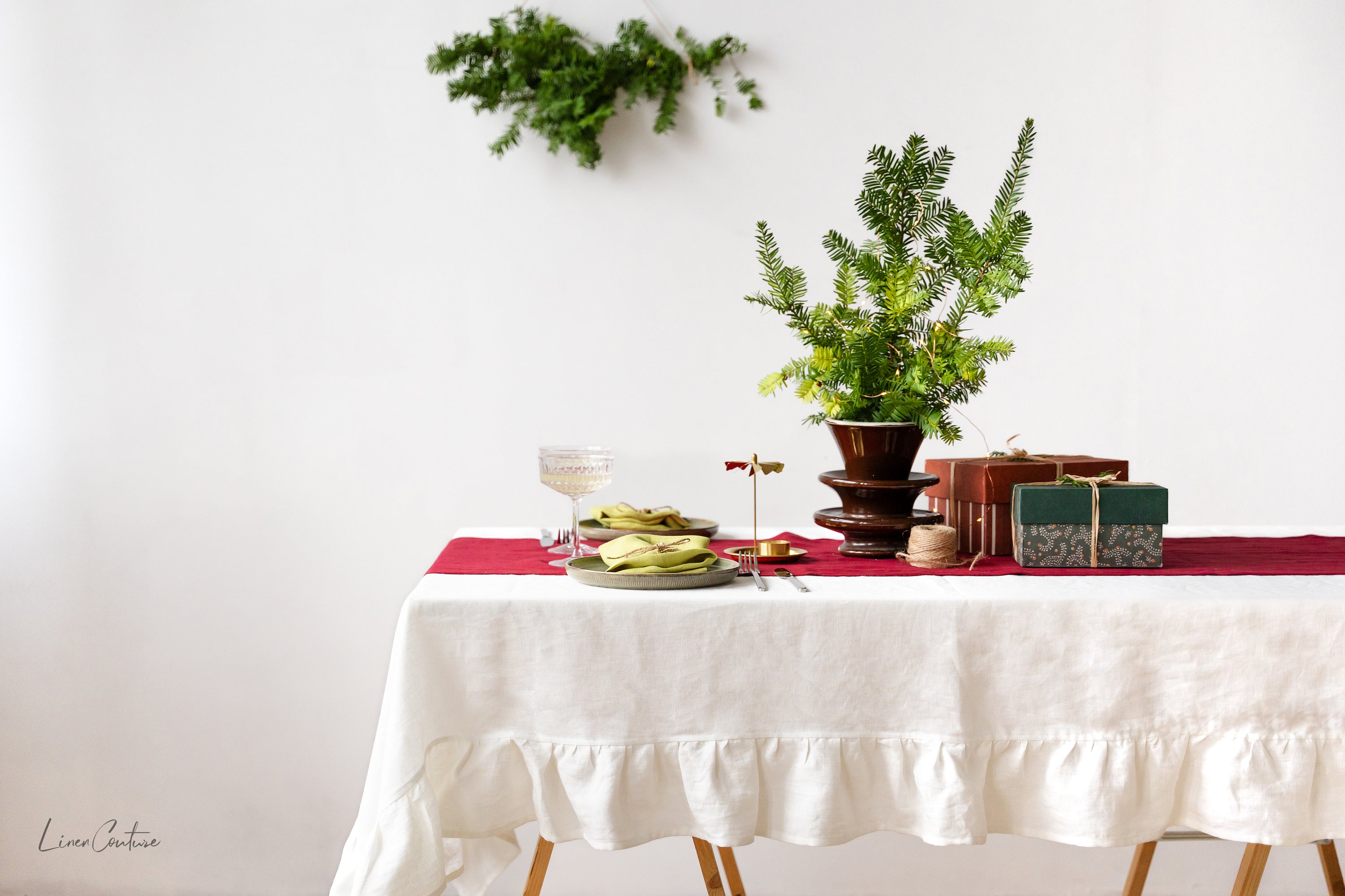 Handmade white linen Christmas tablecloth with elegant ruffles, showcasing premium European linen craftsmanship.