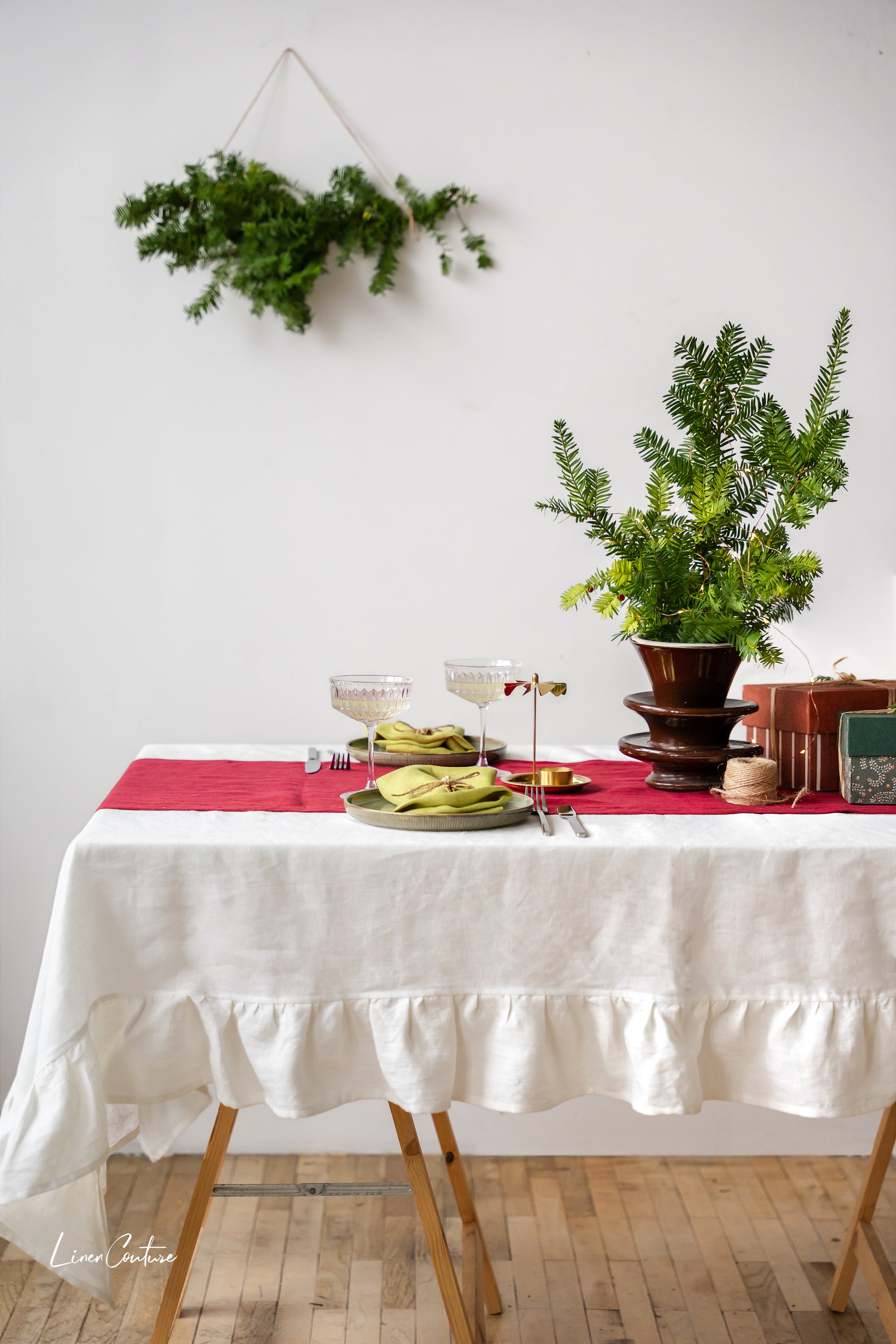 Handmade white linen Christmas tablecloth with elegant ruffles, showcasing premium European linen craftsmanship.