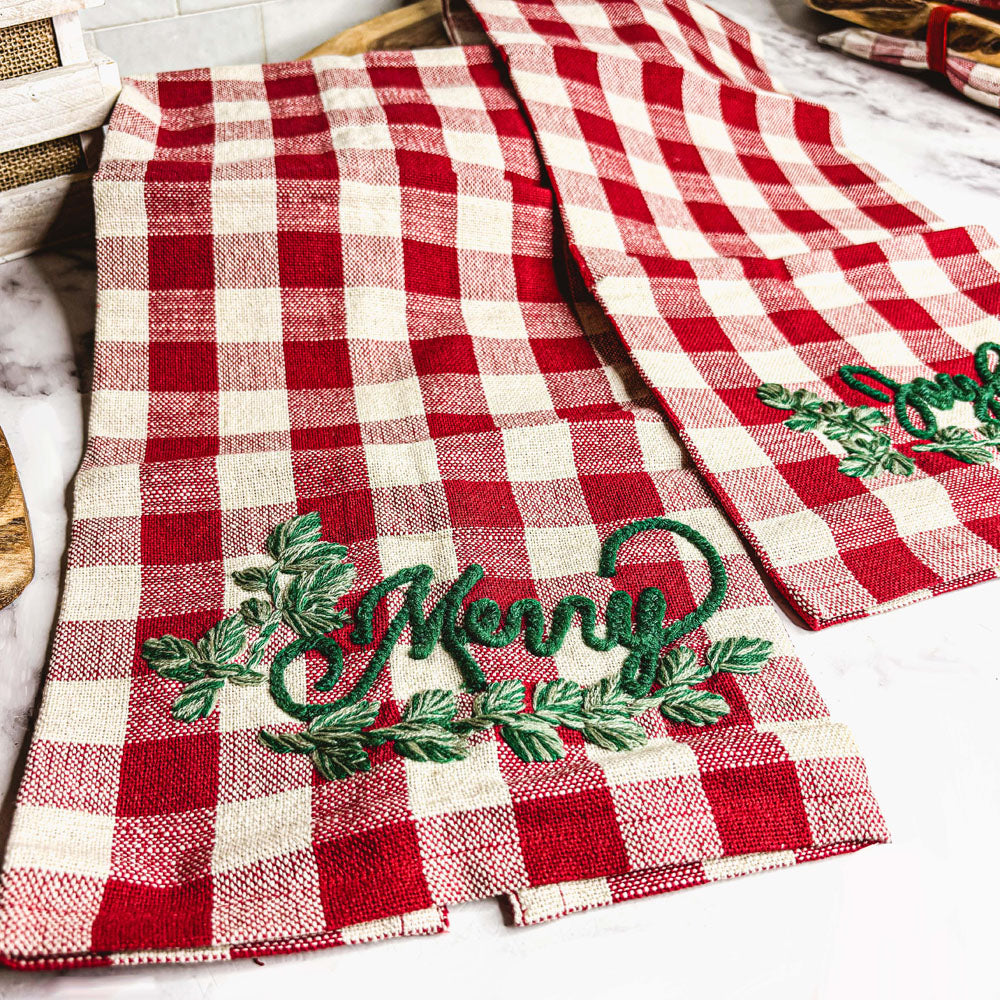 Holiday Charcuterie & Tartan Towel Set featuring a wooden charcuterie board and a tartan print kitchen towel in red and green.