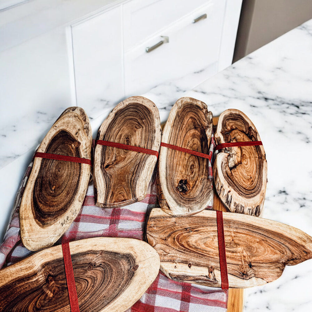 Holiday Charcuterie & Tartan Towel Set featuring a wooden charcuterie board and a tartan print kitchen towel in red and green.