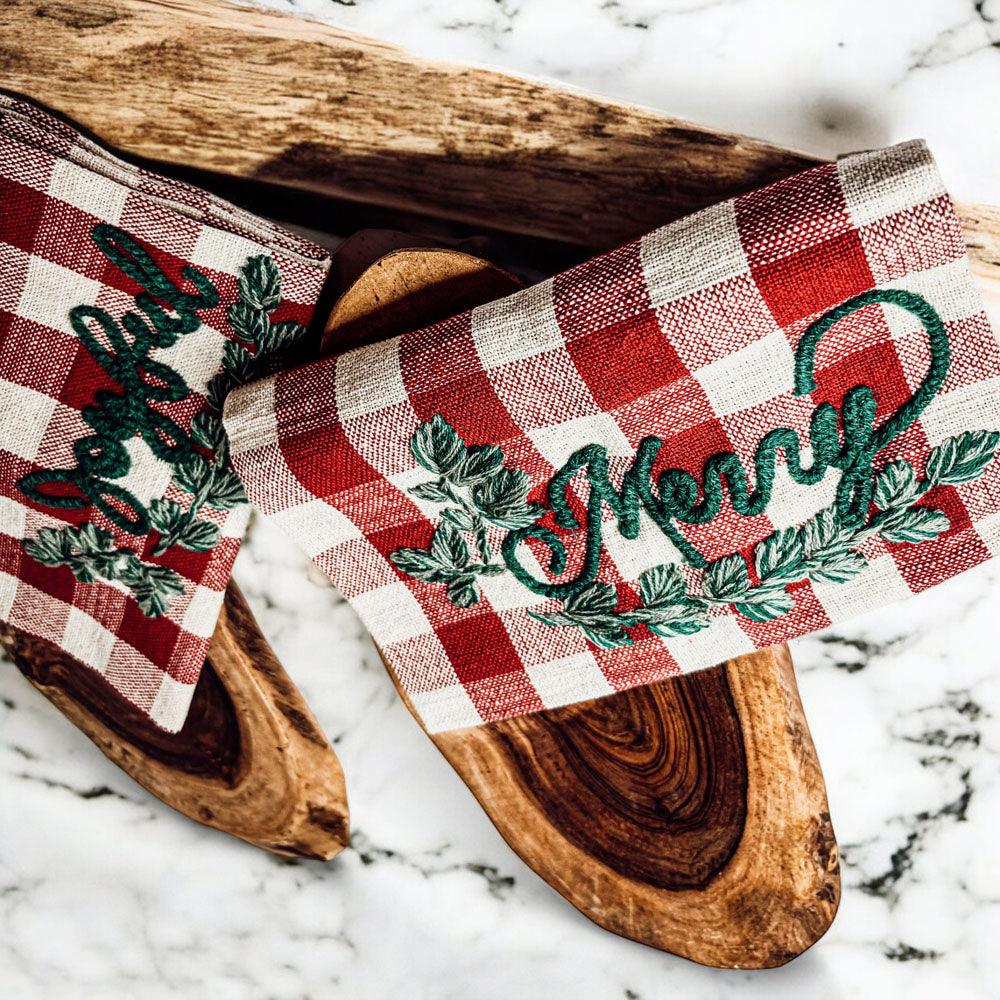 Holiday Charcuterie & Tartan Towel Set featuring a wooden charcuterie board and a tartan print kitchen towel in red and green.