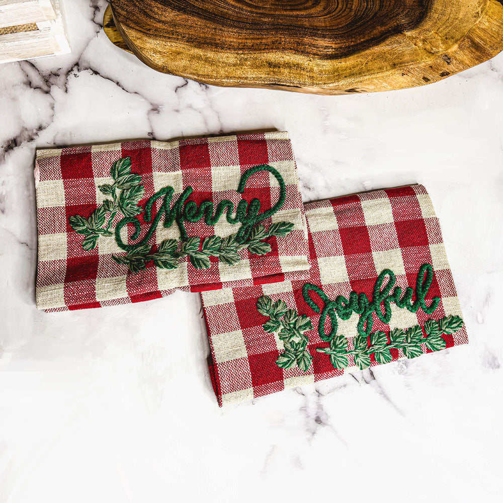 Holiday Charcuterie & Tartan Towel Set featuring a wooden charcuterie board and a tartan print kitchen towel in red and green.