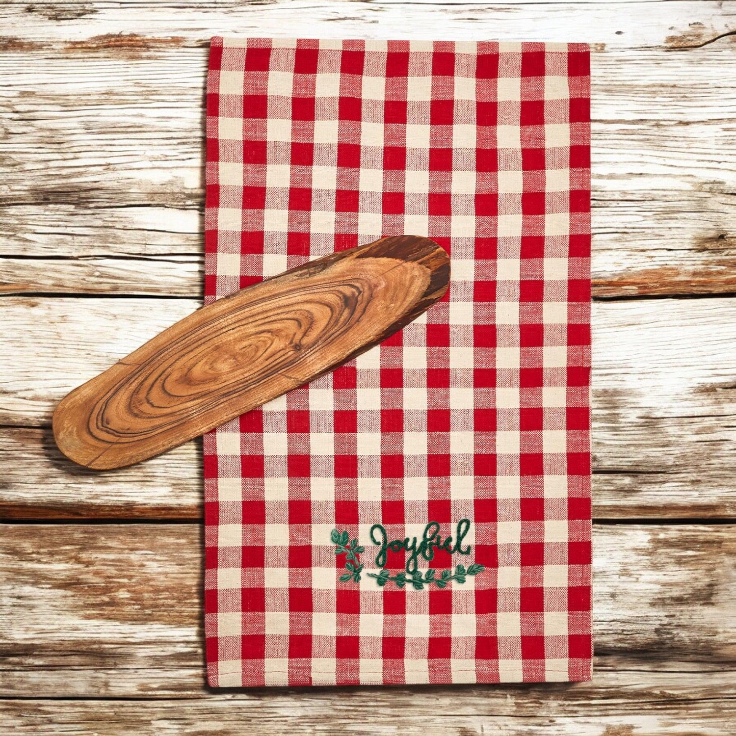 Holiday Charcuterie & Tartan Towel Set featuring a wooden charcuterie board and a tartan print kitchen towel in red and green.