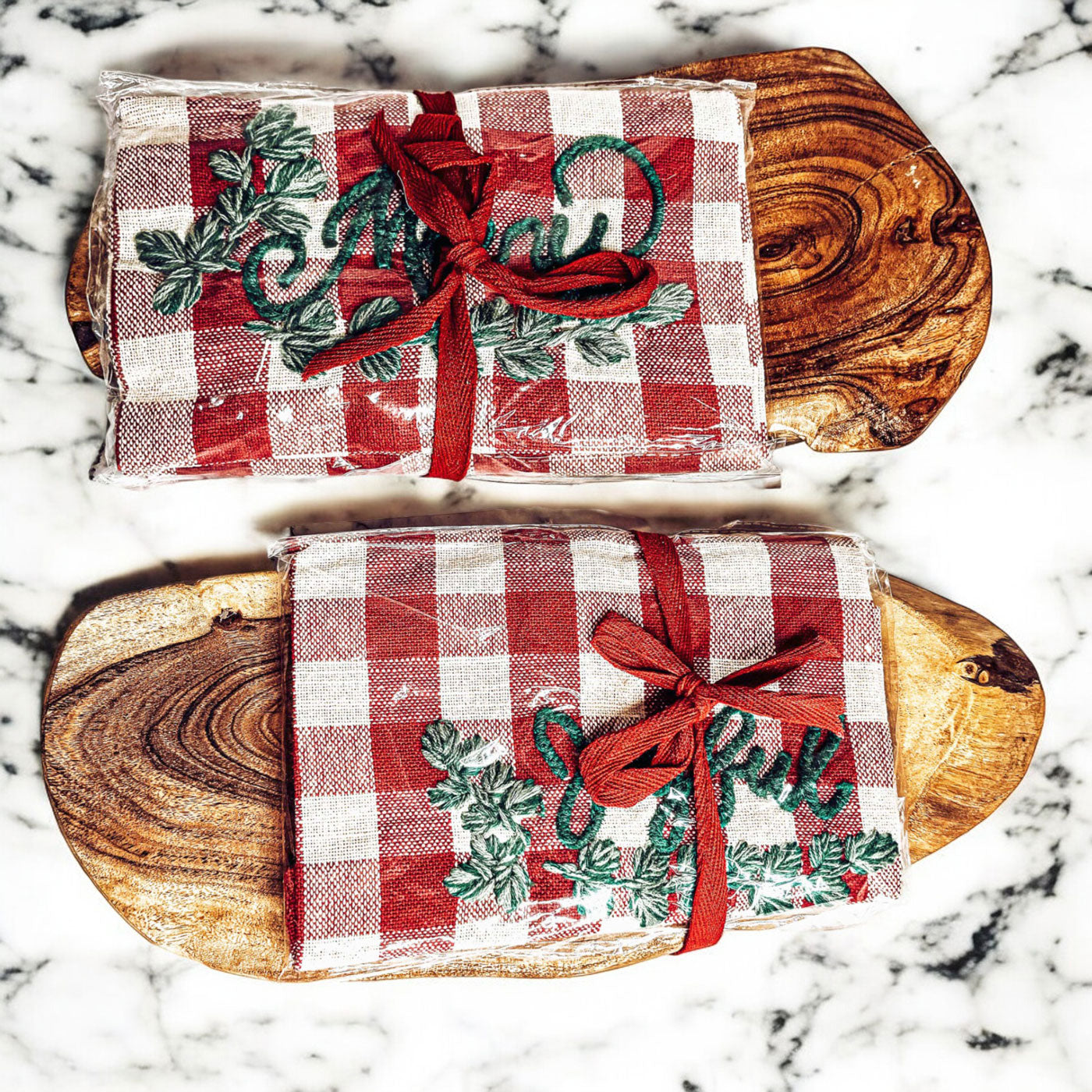 Holiday Charcuterie & Tartan Towel Set featuring a wooden charcuterie board and a tartan print kitchen towel in red and green.