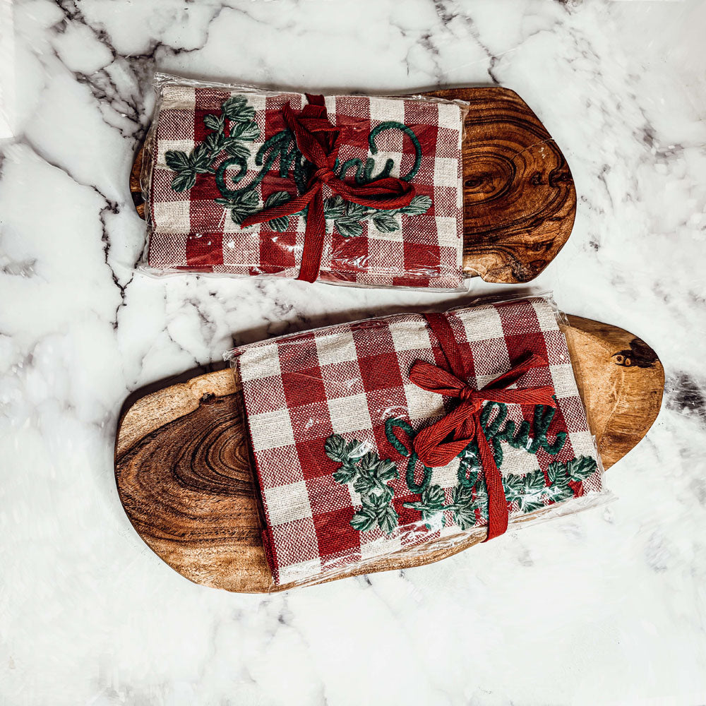 Holiday Charcuterie & Tartan Towel Set featuring a wooden charcuterie board and a tartan print kitchen towel in red and green.