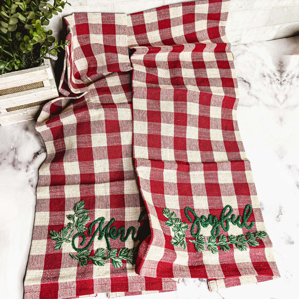 Holiday Charcuterie & Tartan Towel Set featuring a wooden charcuterie board and a tartan print kitchen towel in red and green.