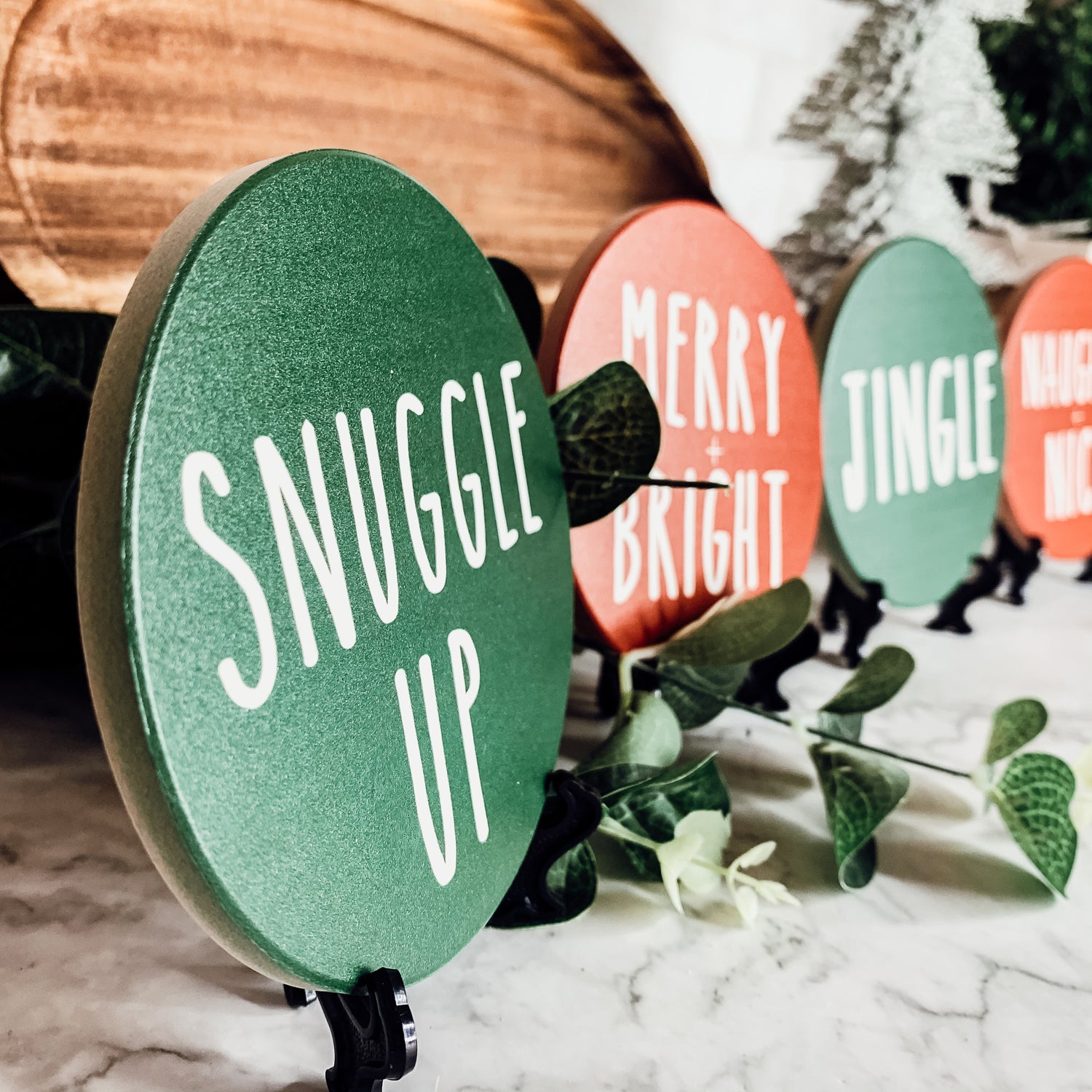 Set of six premium ceramic coasters with cork backing, featuring festive holiday designs including 'Choose Joy' and 'Merry + Bright'.