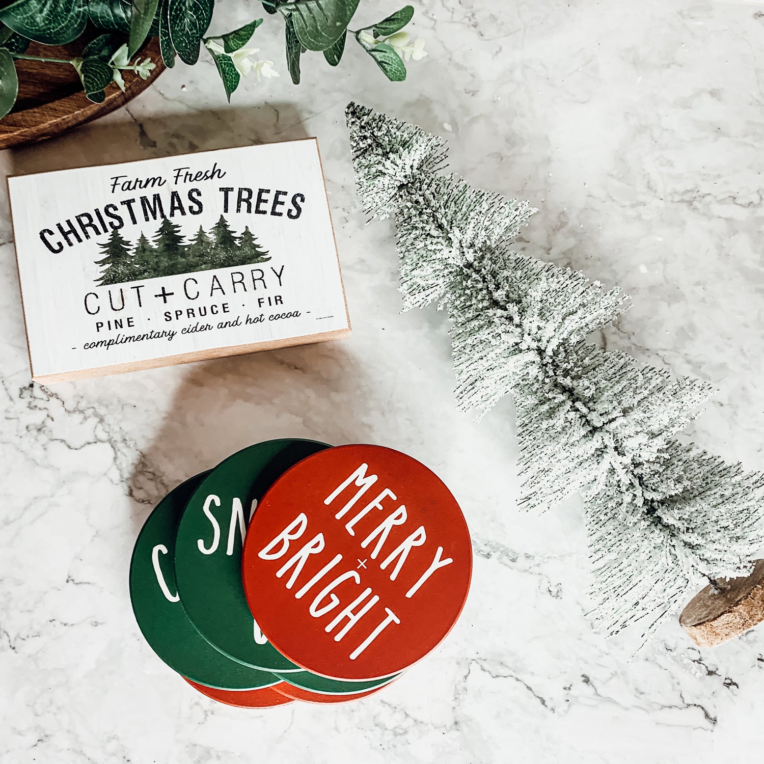 Set of six premium ceramic coasters with cork backing, featuring festive holiday designs including 'Choose Joy' and 'Merry + Bright'.