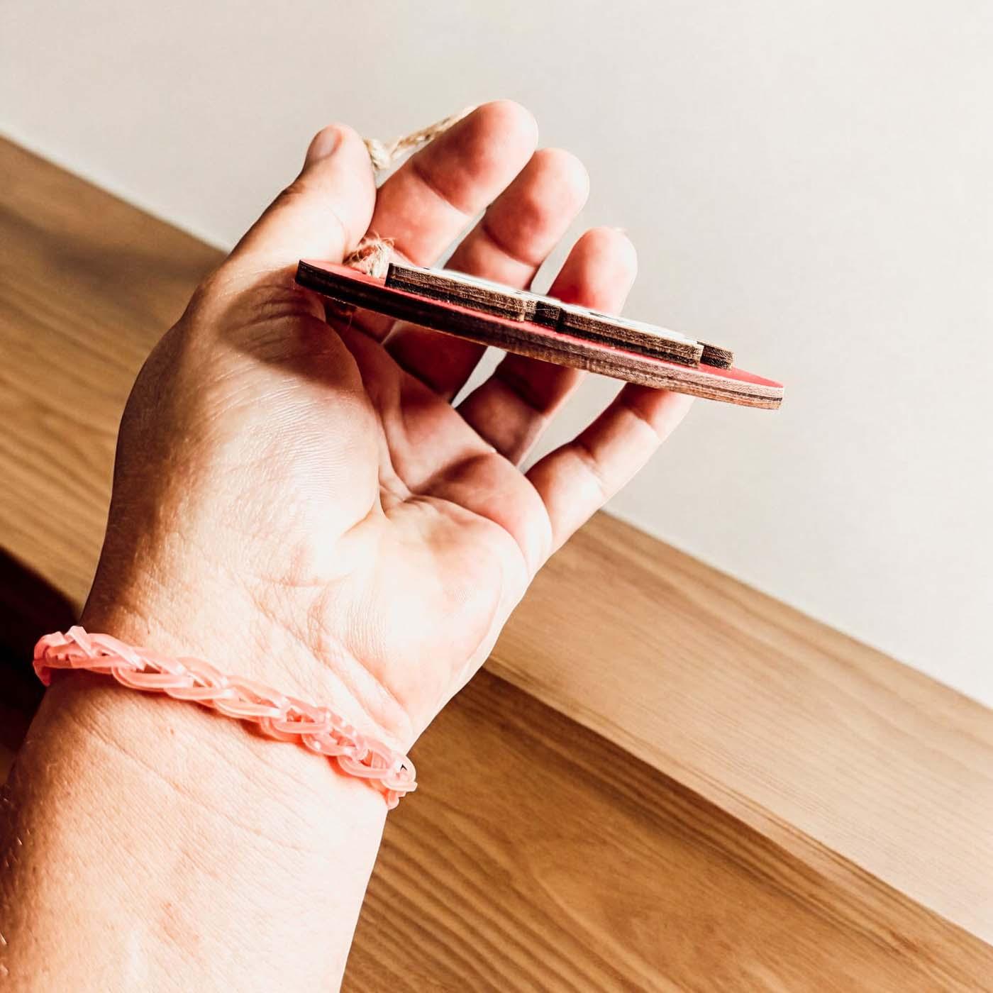 Handcrafted 3D Wooden Christmas Ornaments in various colors, showcasing unique designs and rustic jute twine for hanging.