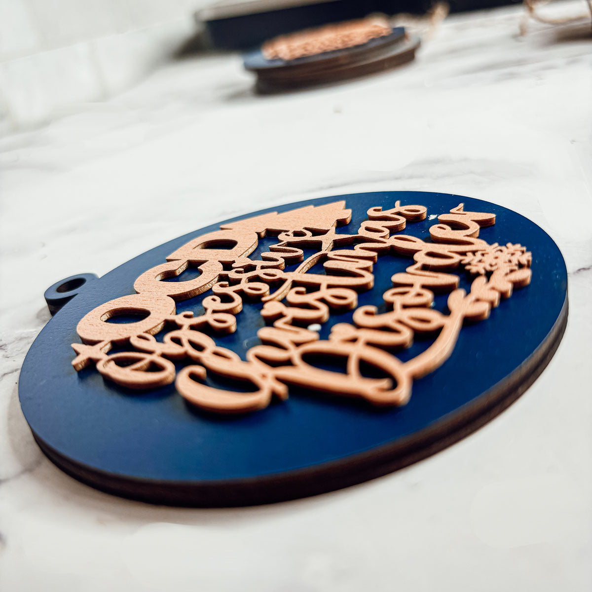 Handcrafted 3D Wooden Christmas Ornaments in various colors, showcasing unique designs and rustic jute twine for hanging.