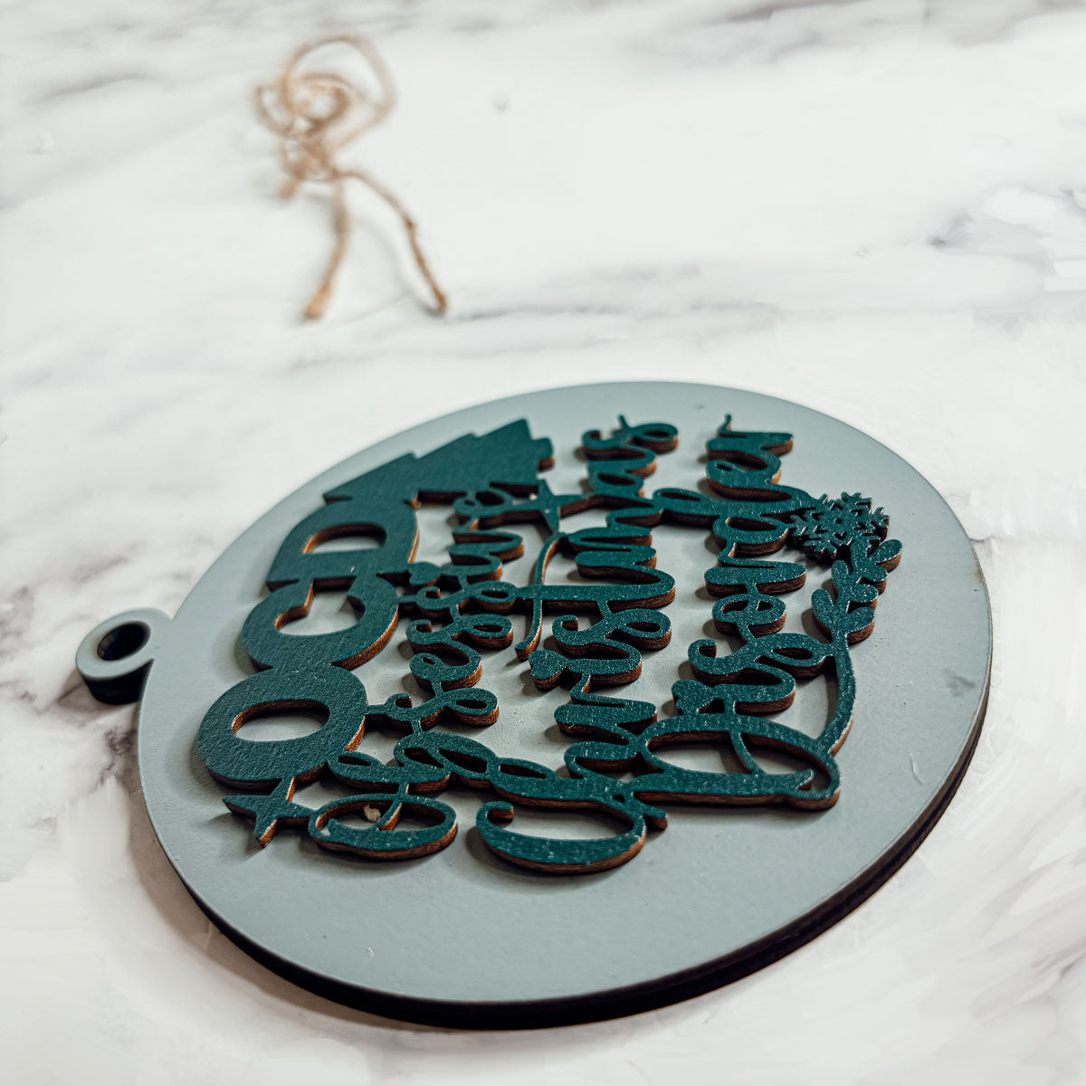 Handcrafted 3D Wooden Christmas Ornaments in various colors, showcasing unique designs and rustic jute twine for hanging.