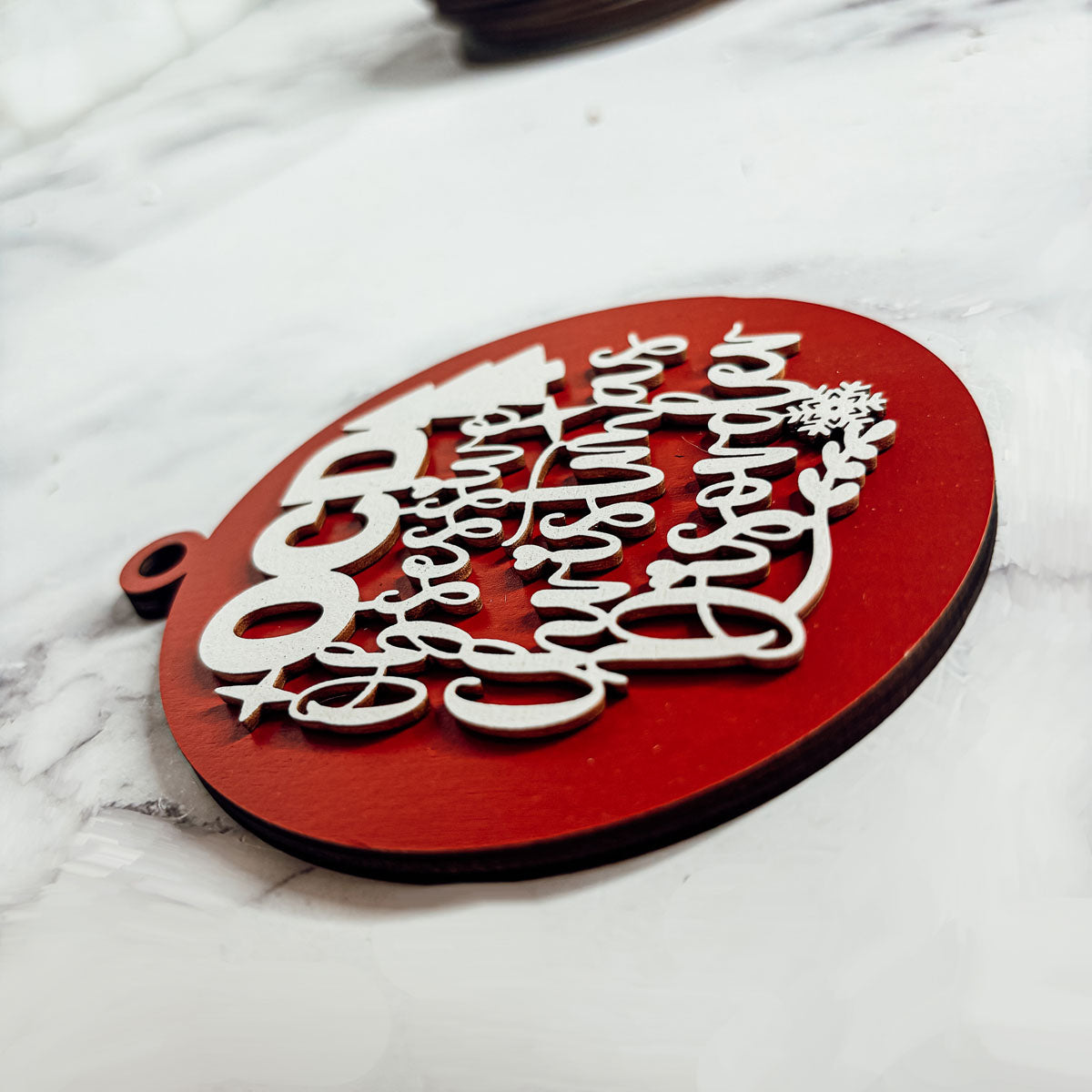 Handcrafted 3D Wooden Christmas Ornaments in various colors, showcasing unique designs and rustic jute twine for hanging.