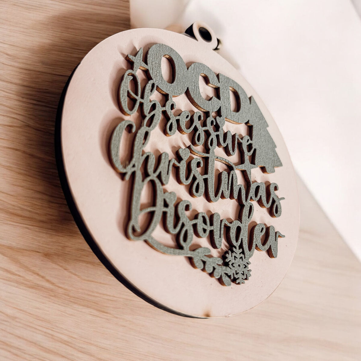 Handcrafted 3D Wooden Christmas Ornaments in various colors, showcasing unique designs and rustic jute twine for hanging.
