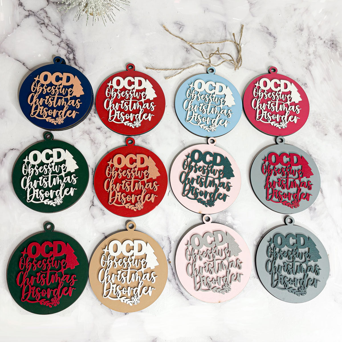 Handcrafted 3D Wooden Christmas Ornaments in various colors, showcasing unique designs and rustic jute twine for hanging.