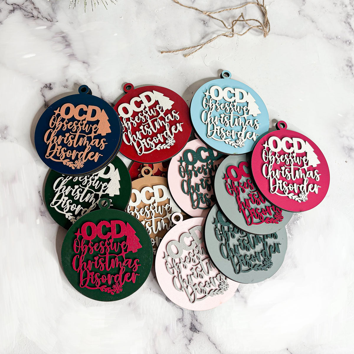 Handcrafted 3D Wooden Christmas Ornaments in various colors, showcasing unique designs and rustic jute twine for hanging.