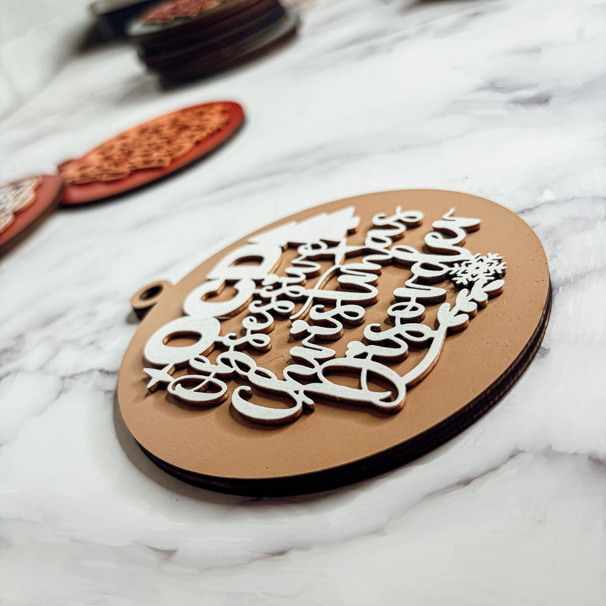 Handcrafted 3D Wooden Christmas Ornaments in various colors, showcasing unique designs and rustic jute twine for hanging.