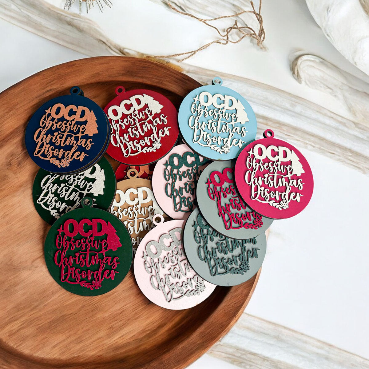 Handcrafted 3D Wooden Christmas Ornaments in various colors, showcasing unique designs and rustic jute twine for hanging.