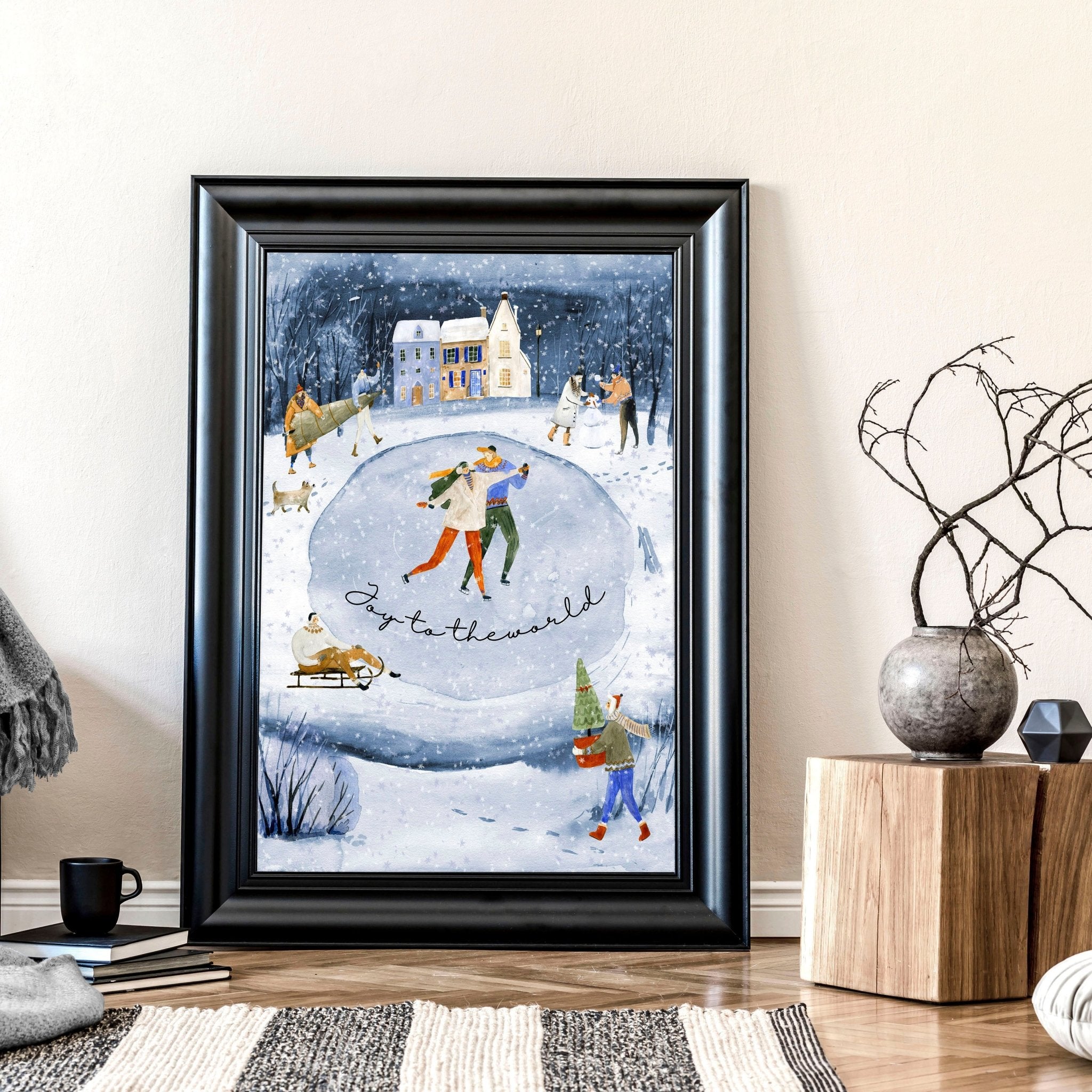 A beautiful indoor Christmas wall art print featuring a serene blue watercolour landscape with a snowy pond and a charming village adorned with lights.