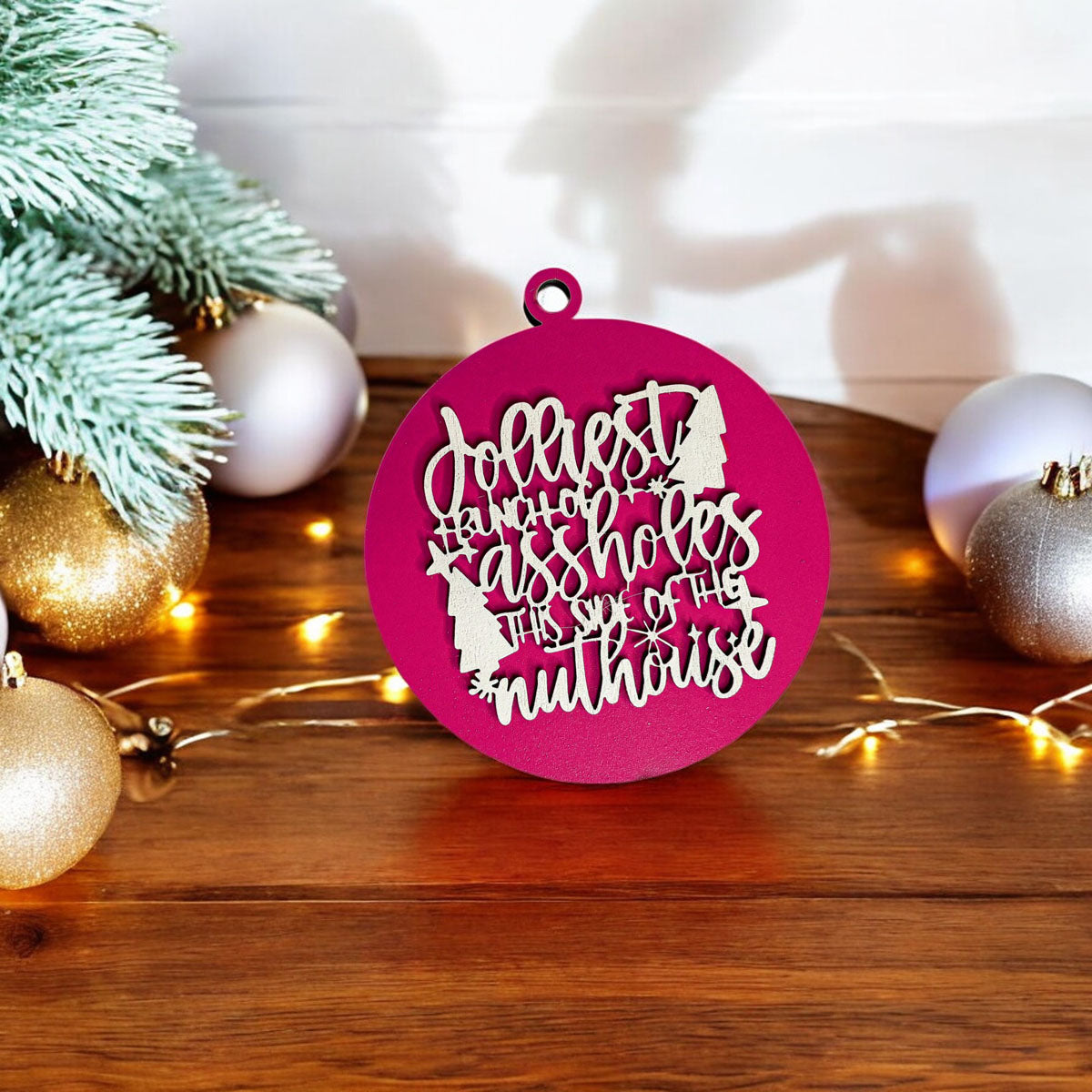 Jolliest Bunch Wooden Ornament featuring festive graphics and rustic twine, available in 12 vibrant colors.