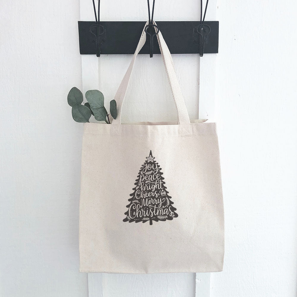 Joy Christmas Tree Canvas Tote Bag featuring a vibrant Christmas tree design on durable fabric.