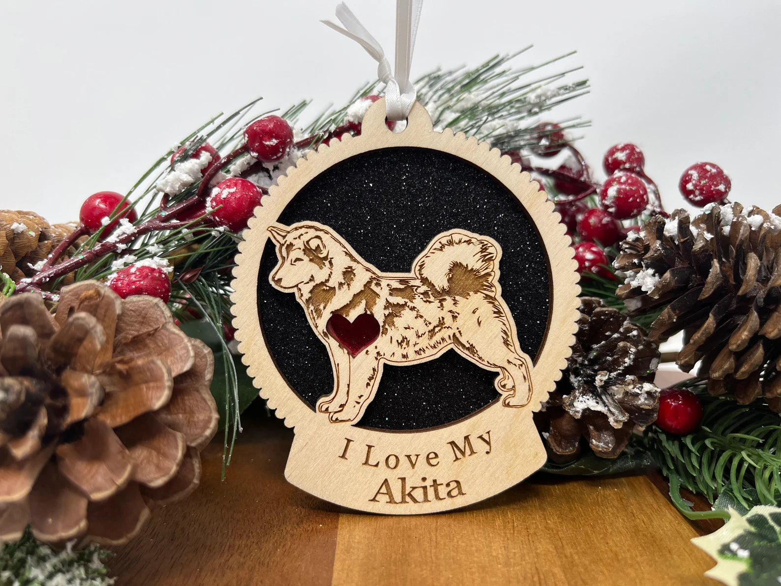 A beautifully crafted laser-cut wooden ornament featuring an Akita silhouette, perfect for holiday decorations.