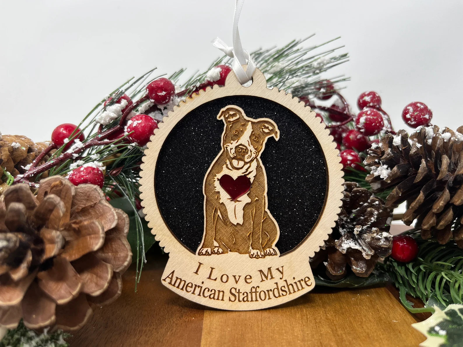 Laser cut wooden ornament featuring an American Staffordshire silhouette, perfect for holiday decor.