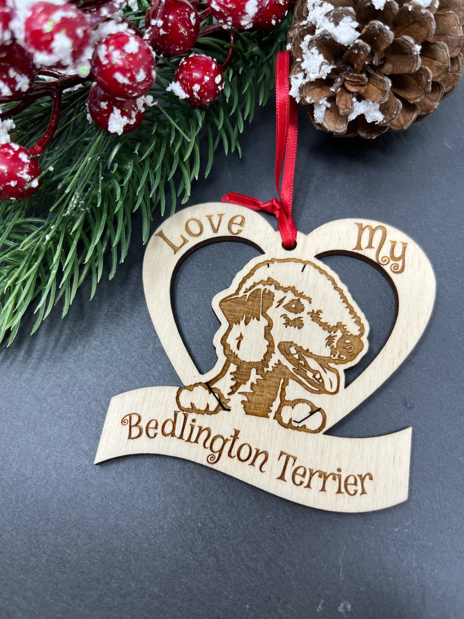 A beautifully laser engraved wooden ornament featuring a Bedlington Terrier, perfect for Christmas decoration.