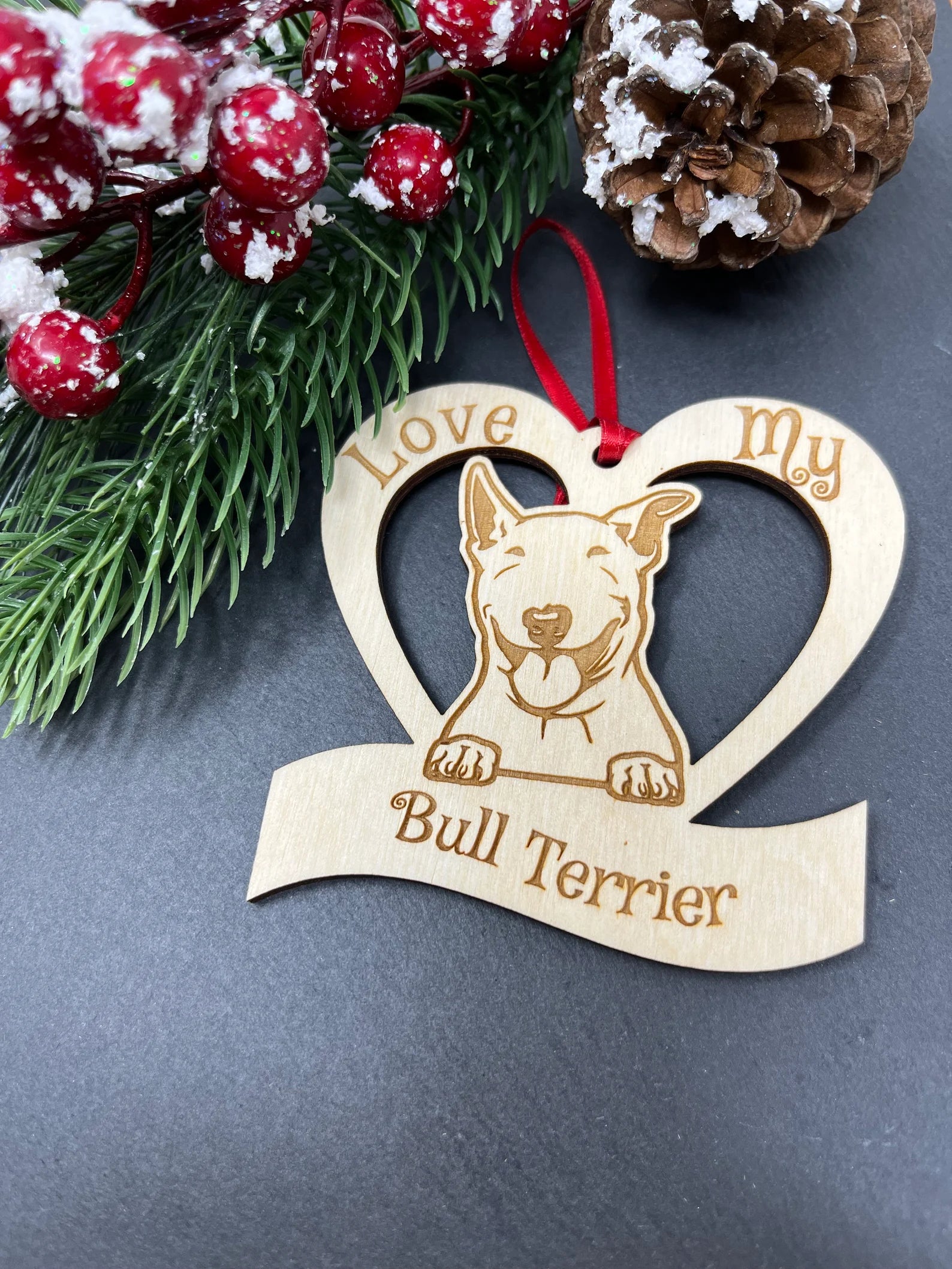 Laser engraved wooden ornament featuring a Bull Terrier design, perfect for Christmas decoration.
