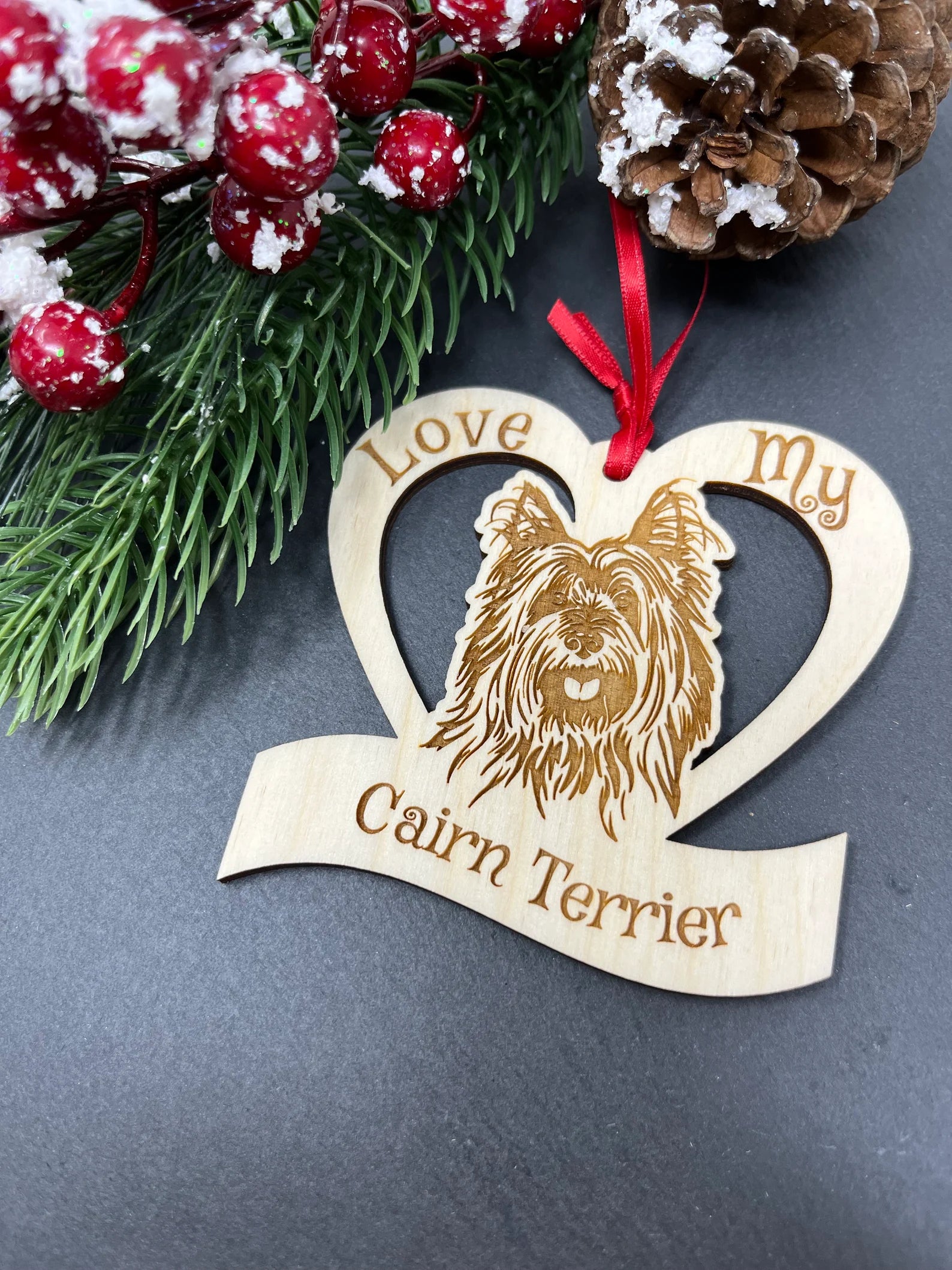 Laser engraved wooden ornament featuring a Cairn Terrier design, perfect for Christmas decoration.