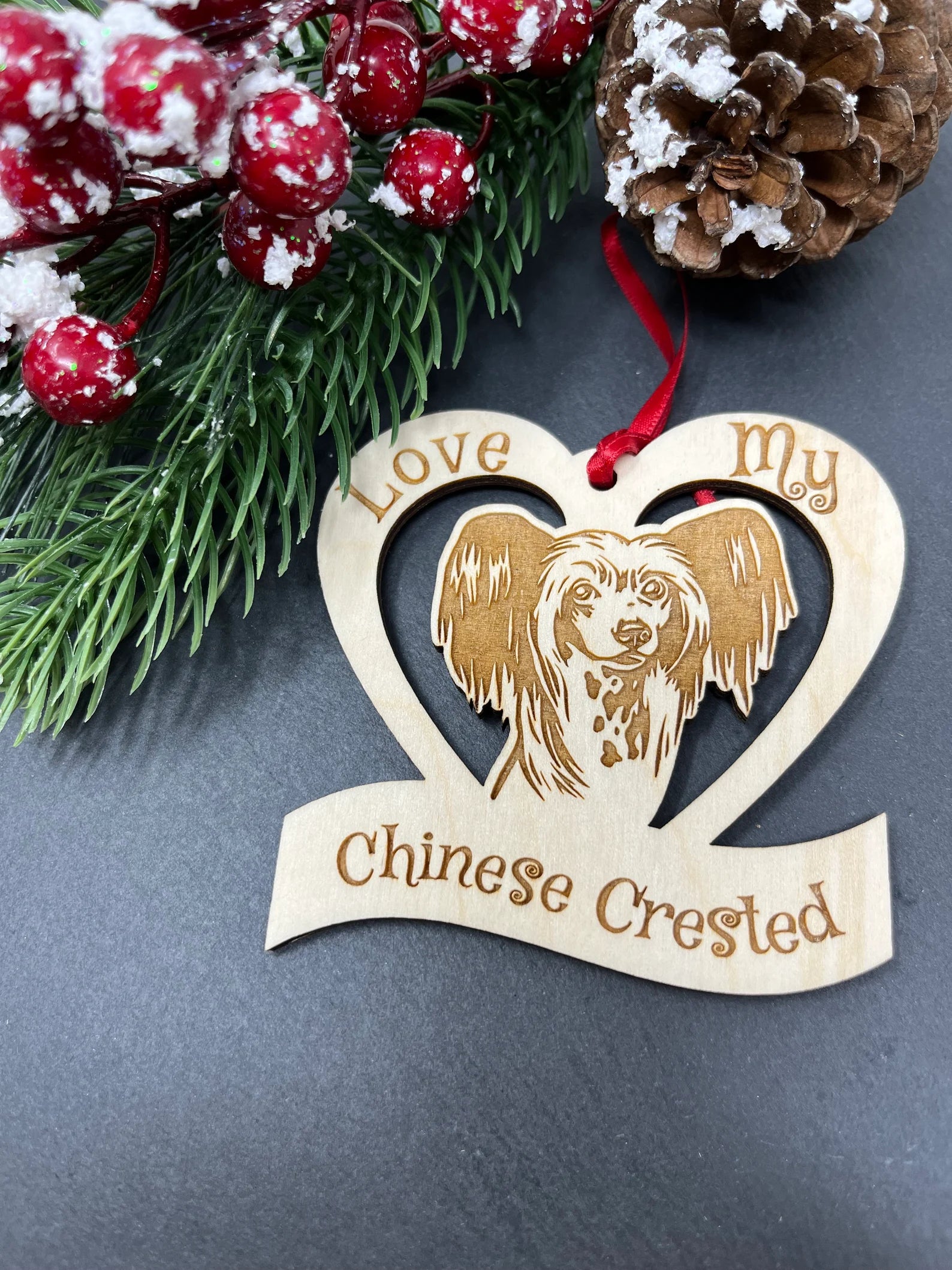 Love My Chinese Crested ornament made from laser engraved Baltic Birch wood, featuring a unique design and attached ribbon for hanging.