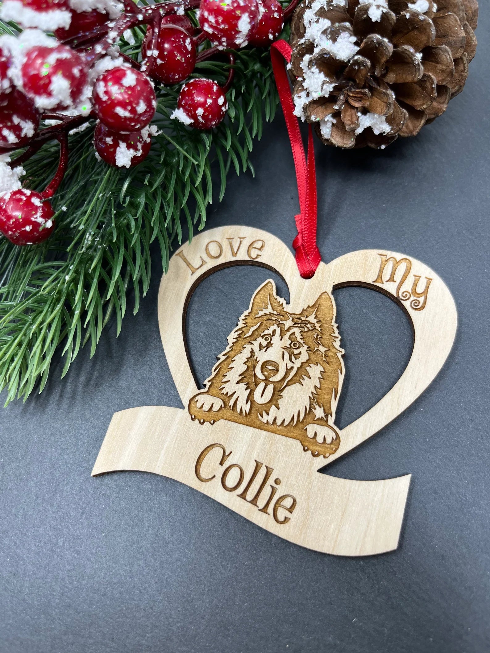 Laser engraved wooden ornament featuring a collie design, perfect for Christmas decoration.