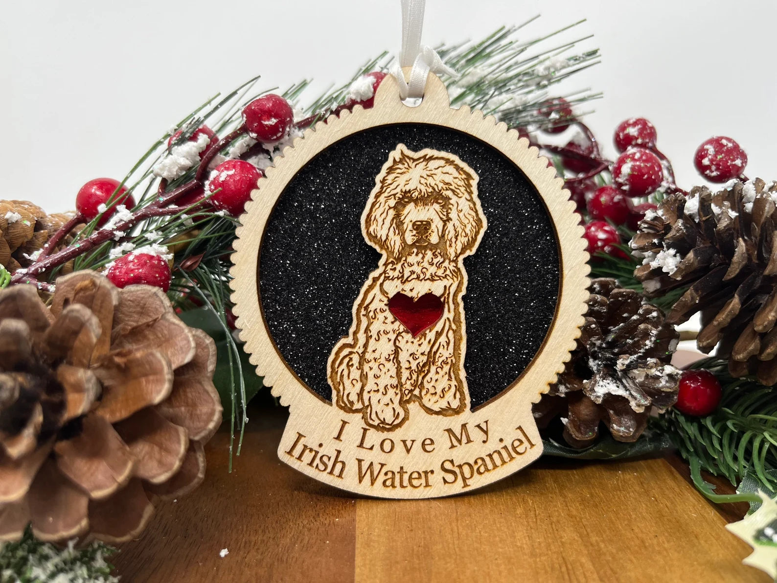 A beautifully crafted laser-cut wooden ornament featuring the silhouette of an Irish Water Spaniel, perfect for holiday decor.