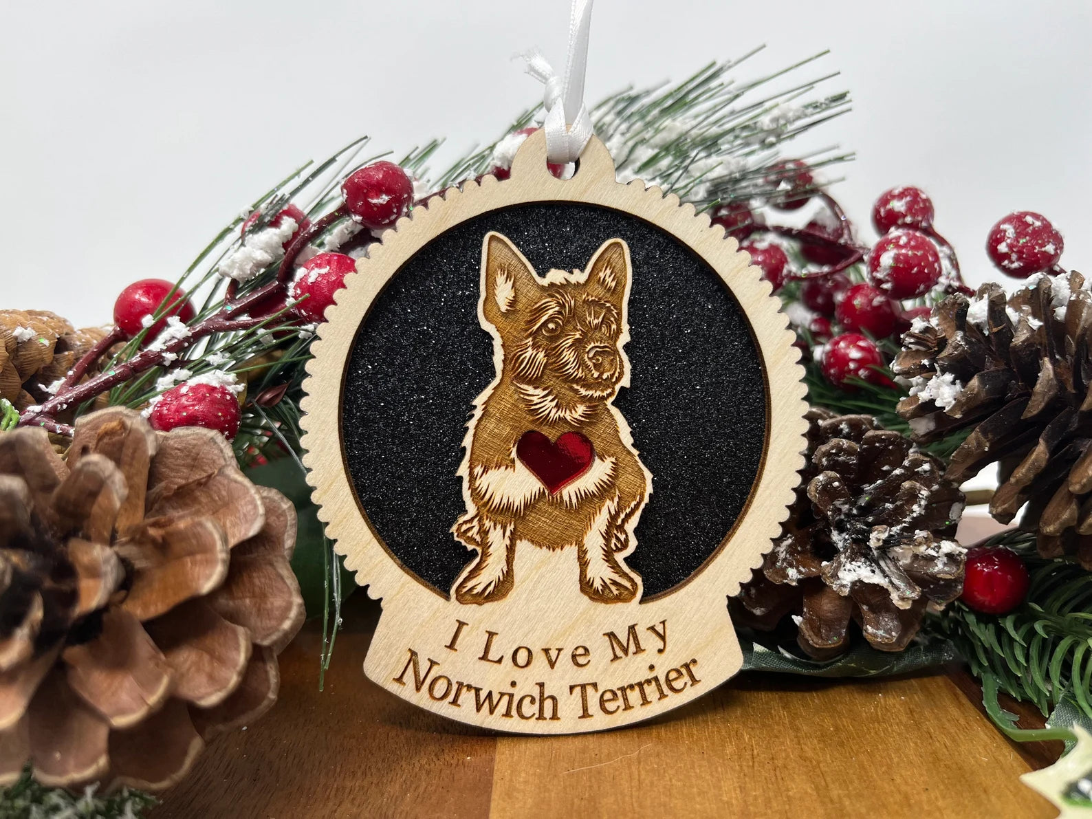 Laser cut wooden ornament featuring a Norwich Terrier silhouette, perfect for Christmas decoration.