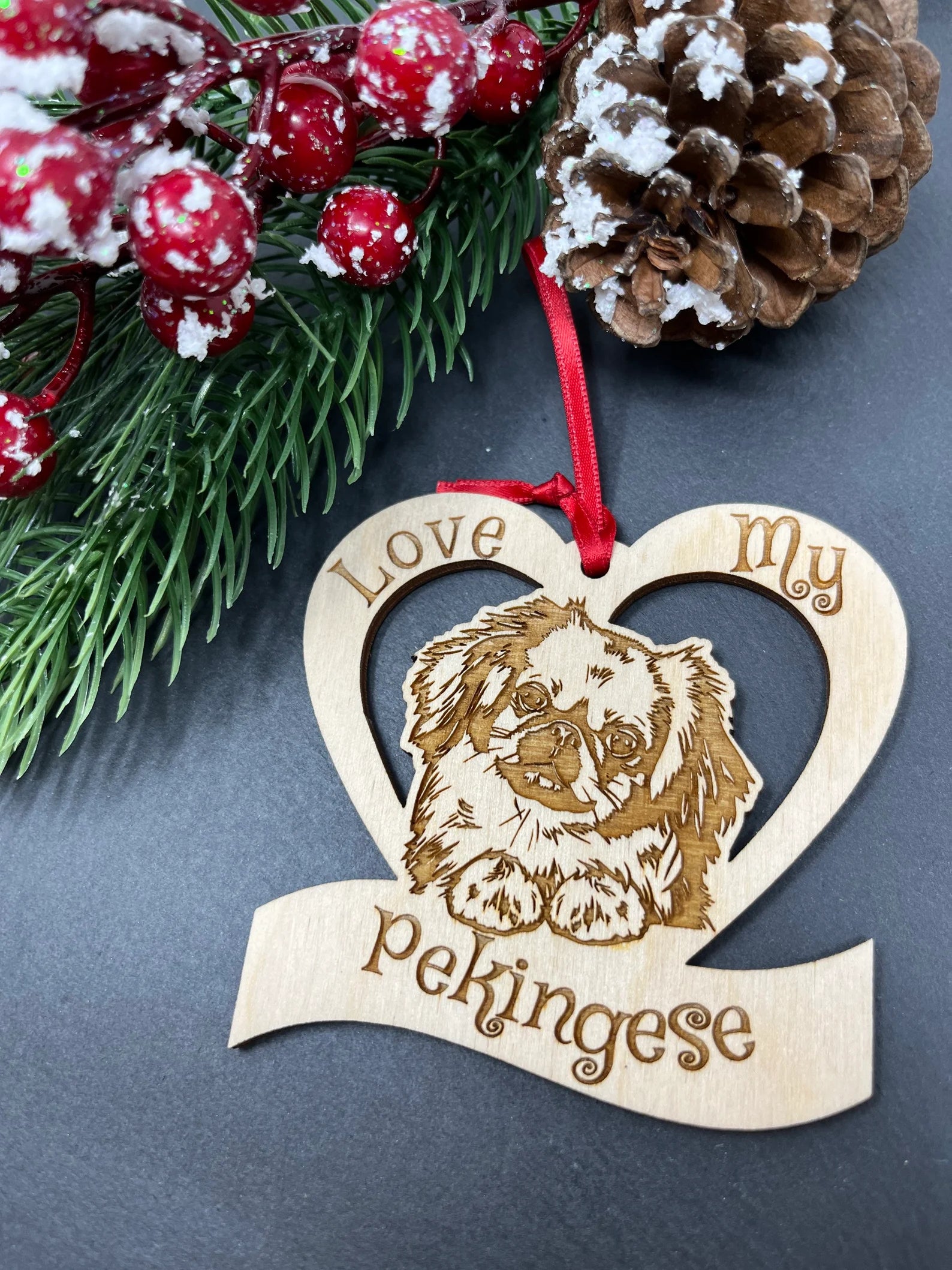 A beautifully laser engraved wooden ornament featuring a Pekingese dog, perfect for Christmas decoration.