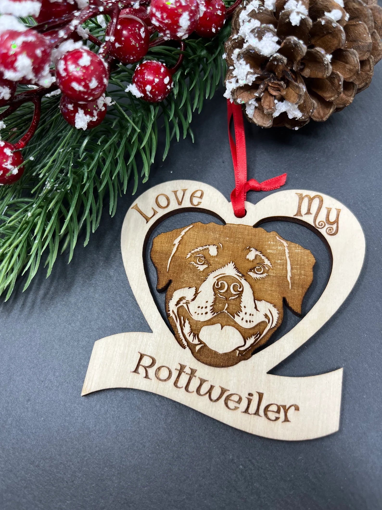Laser engraved wooden ornament featuring a Rottweiler design, perfect for Christmas decoration.