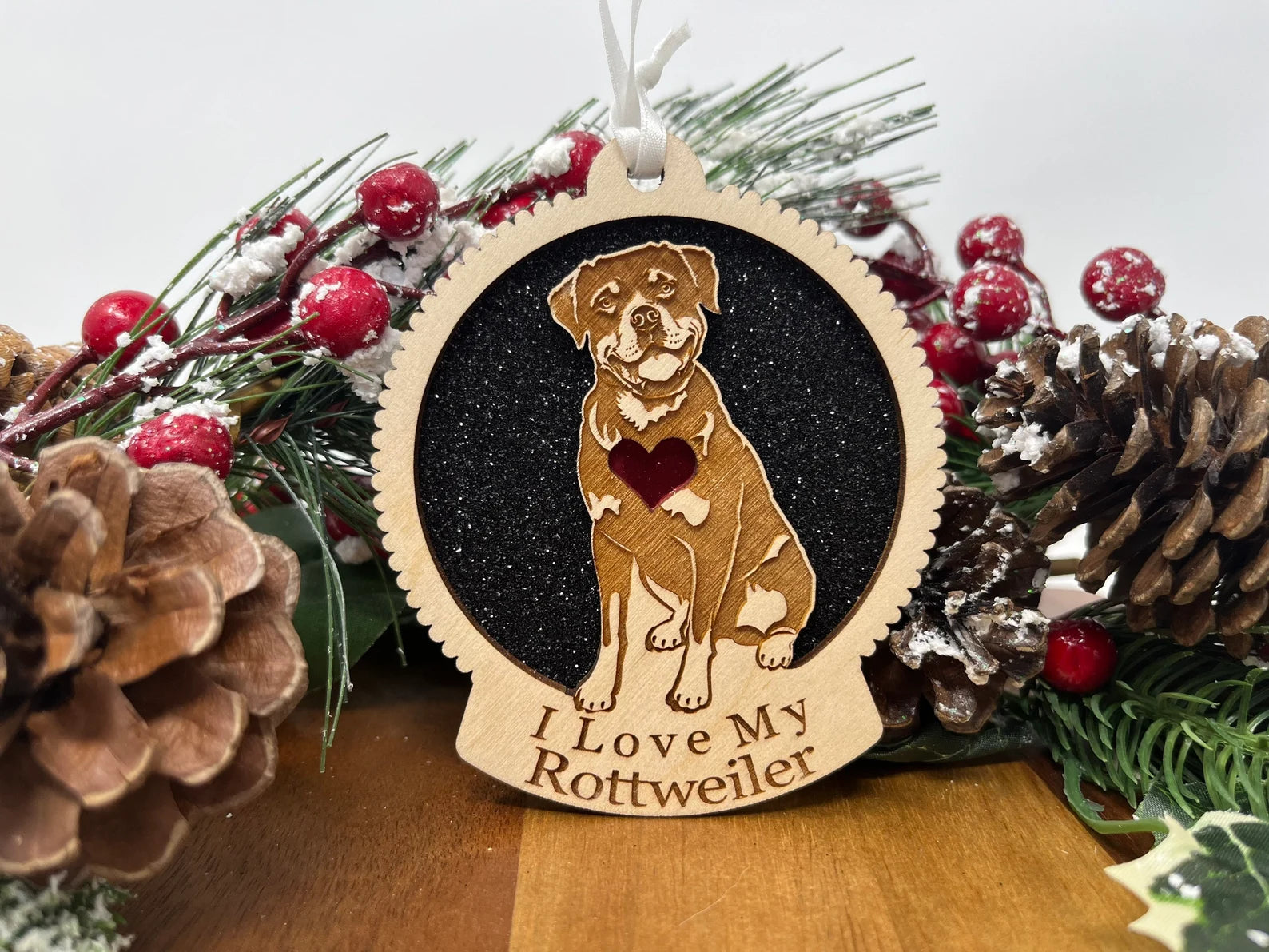 A beautifully crafted wooden ornament featuring a Rottweiler silhouette, perfect for Christmas decorations.