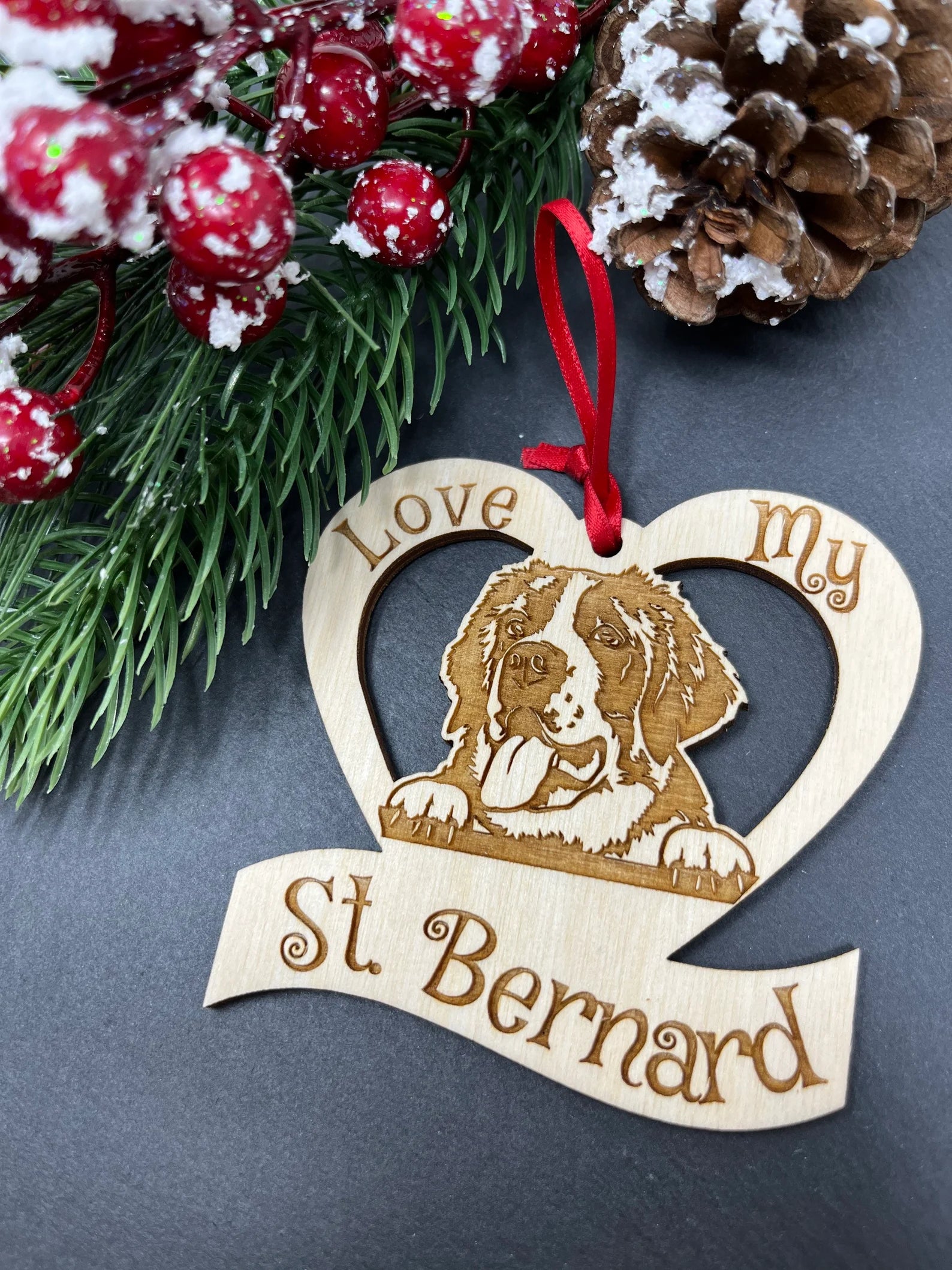 Love My Saint Bernard ornament made of laser engraved Baltic Birch wood, featuring a unique design and attached ribbon for hanging.