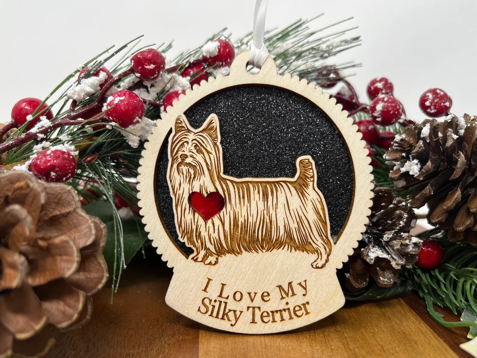 A beautifully crafted Love My Silky Terrier ornament made from laser-cut Baltic Birch wood, featuring a silhouette of a Silky Terrier, ready to hang with a ribbon.