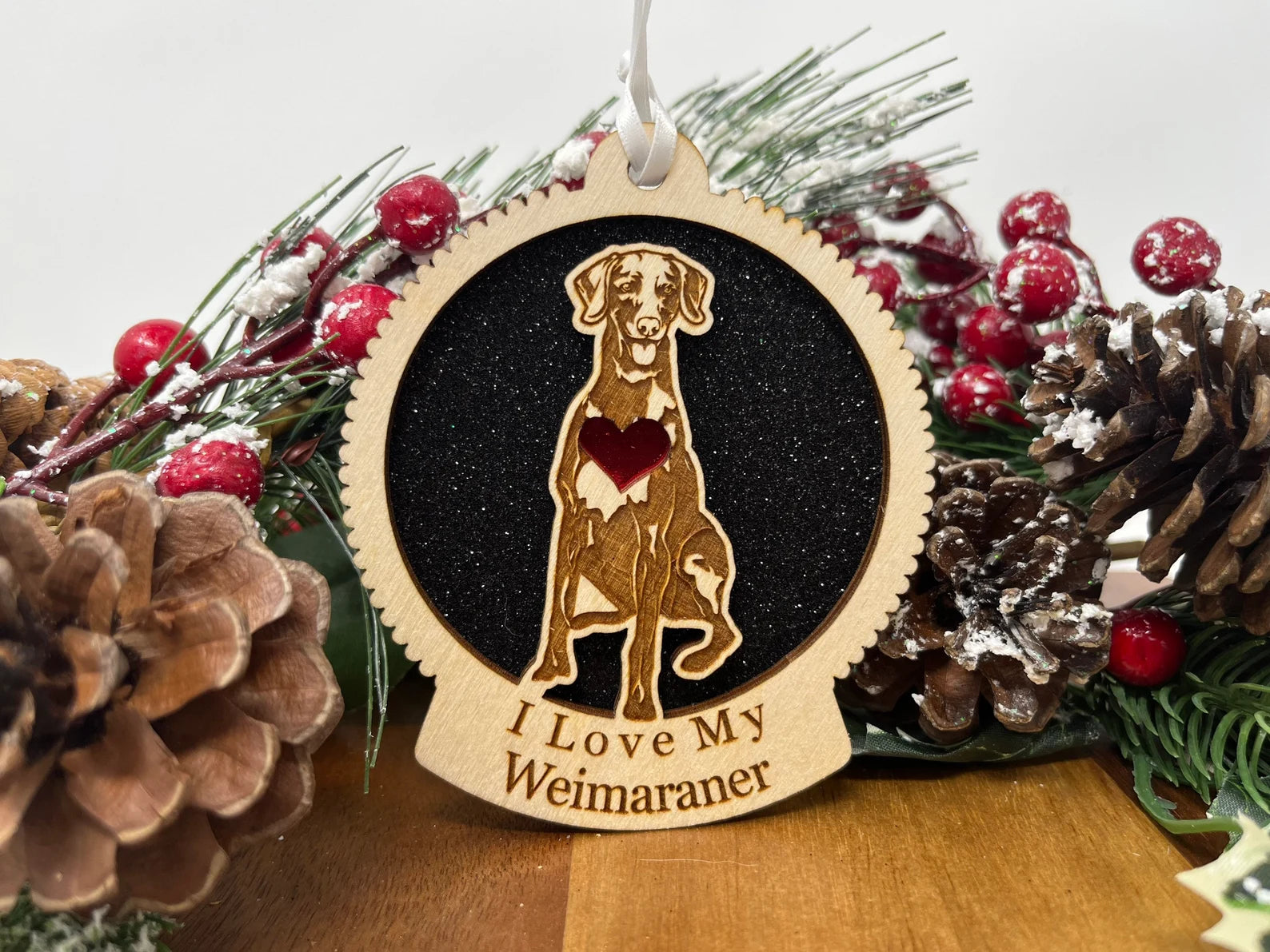 A beautifully crafted wooden ornament featuring a silhouette of a Weimaraner, perfect for Christmas decoration.