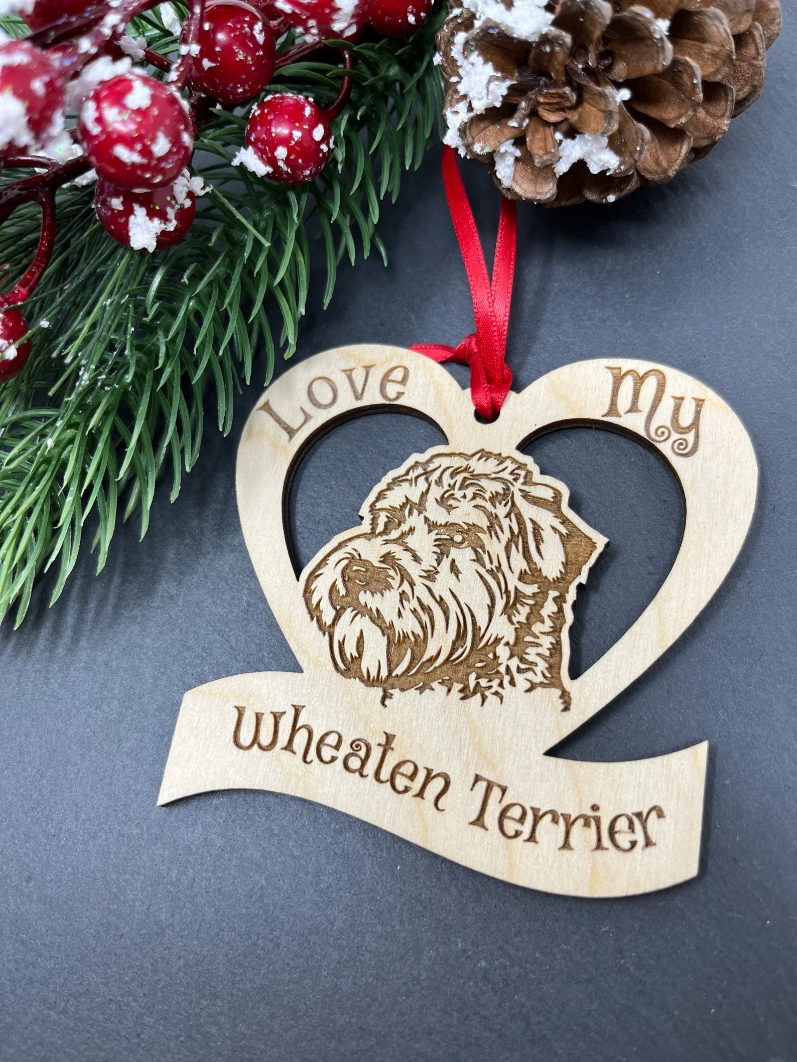 A beautifully laser engraved wooden ornament featuring a Wheaten Terrier, perfect for Christmas decoration.