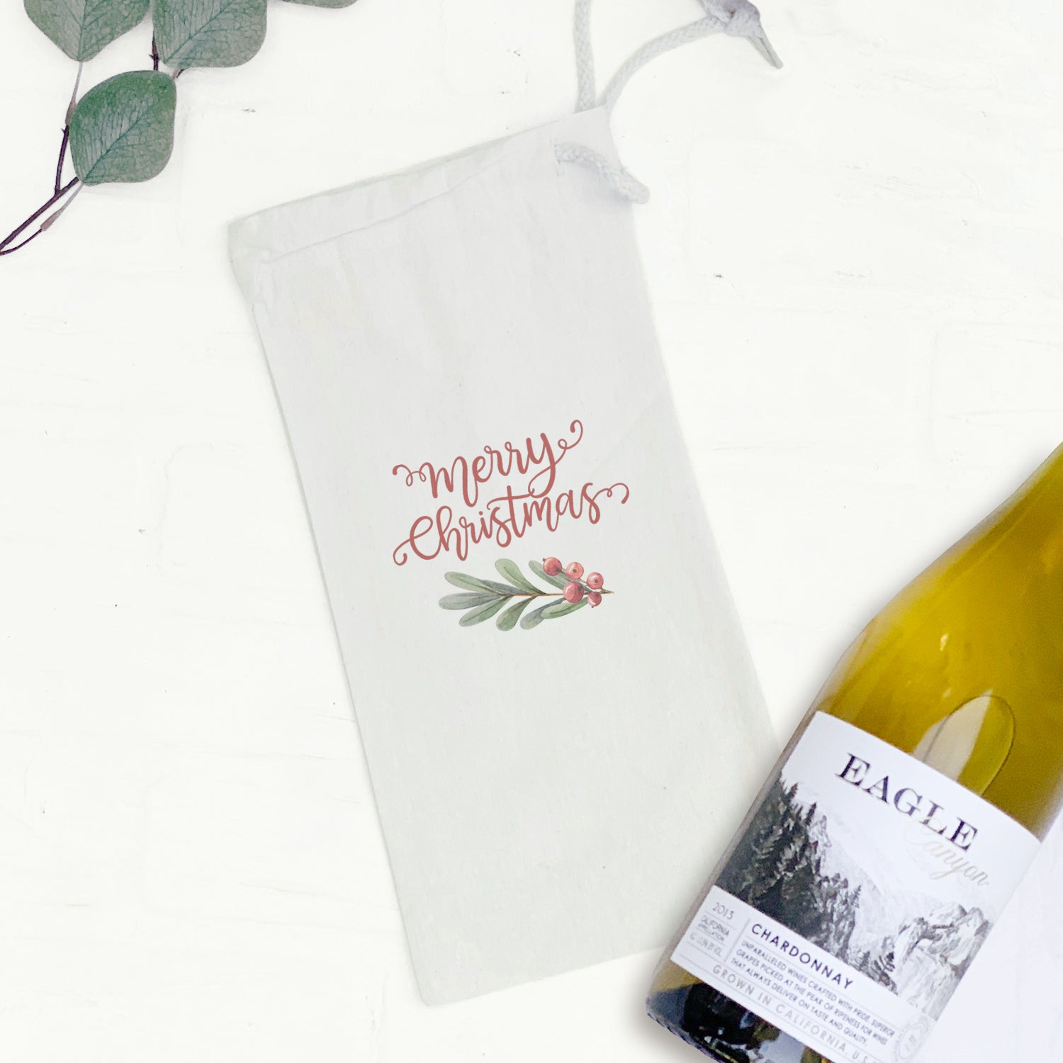 Merry Christmas Sprig canvas wine bag featuring festive design and drawstring closure, perfect for gifting wine.