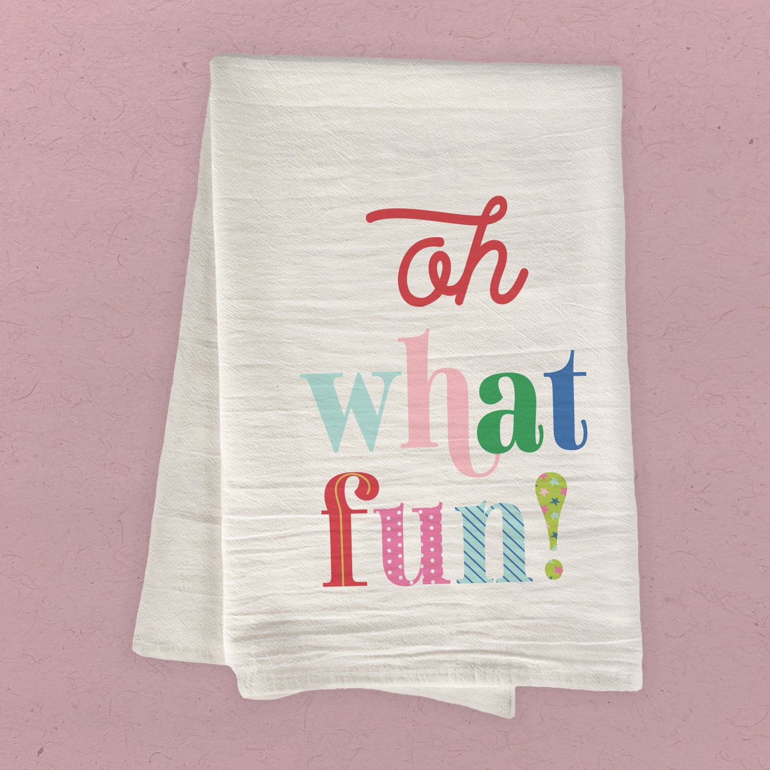 Oh What Fun Cotton Tea Towel featuring vibrant designs and hemmed edges, perfect for kitchen use.