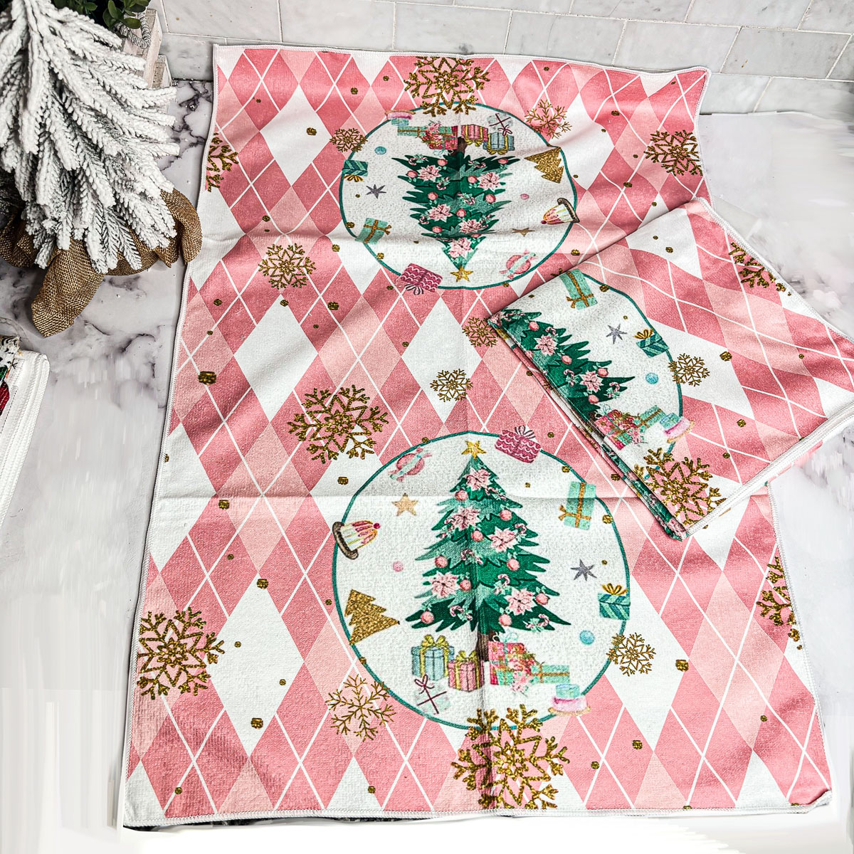 A soft and absorbent Pink Christmas Hand Towel featuring festive designs, perfect for holiday kitchen decor.