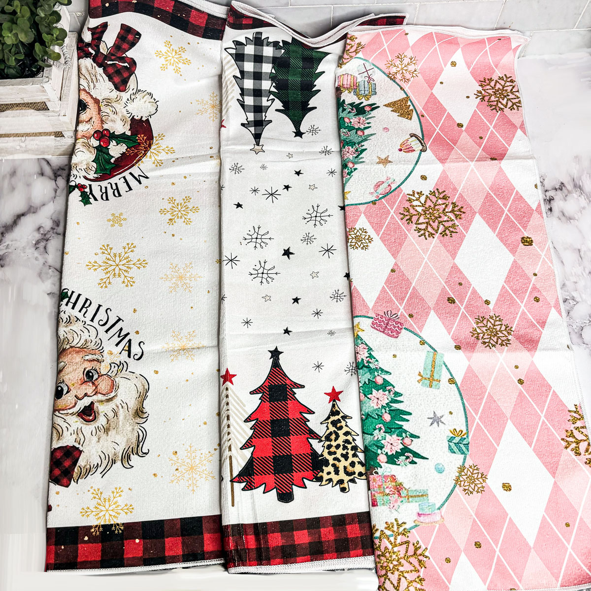 A soft and absorbent Pink Christmas Hand Towel featuring festive designs, perfect for holiday kitchen decor.