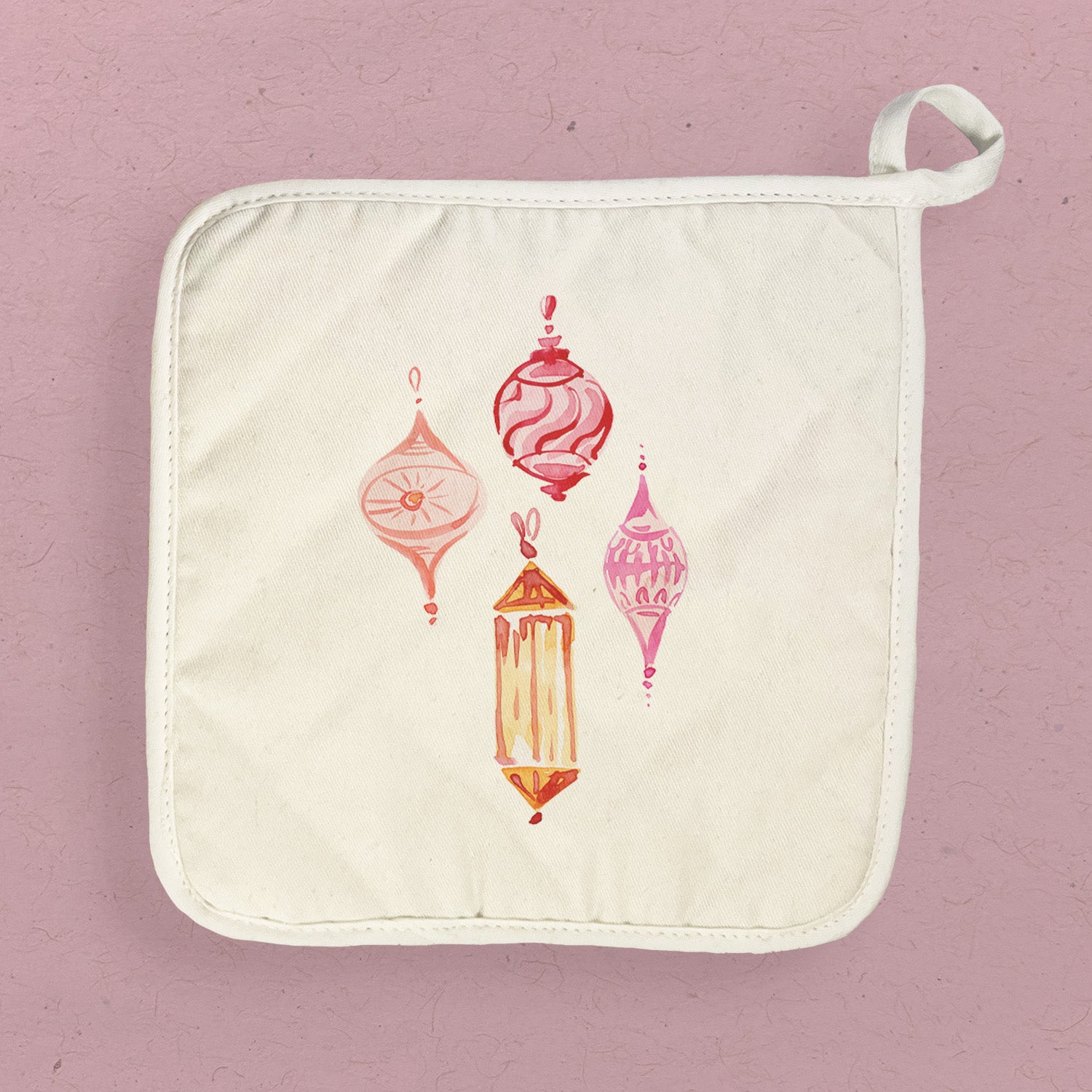 A vibrant pink cotton pot holder featuring decorative ornaments, perfect for protecting surfaces from hot cookware.
