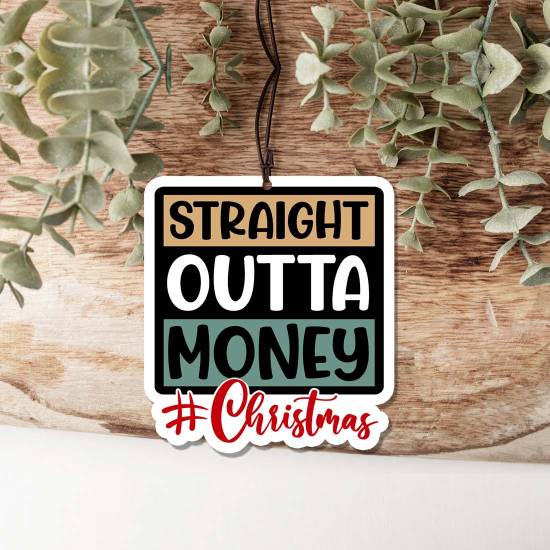 Straight Outta $ Freshie hanging air freshener in a stylish design, showcasing its vibrant colors and appealing scent options.